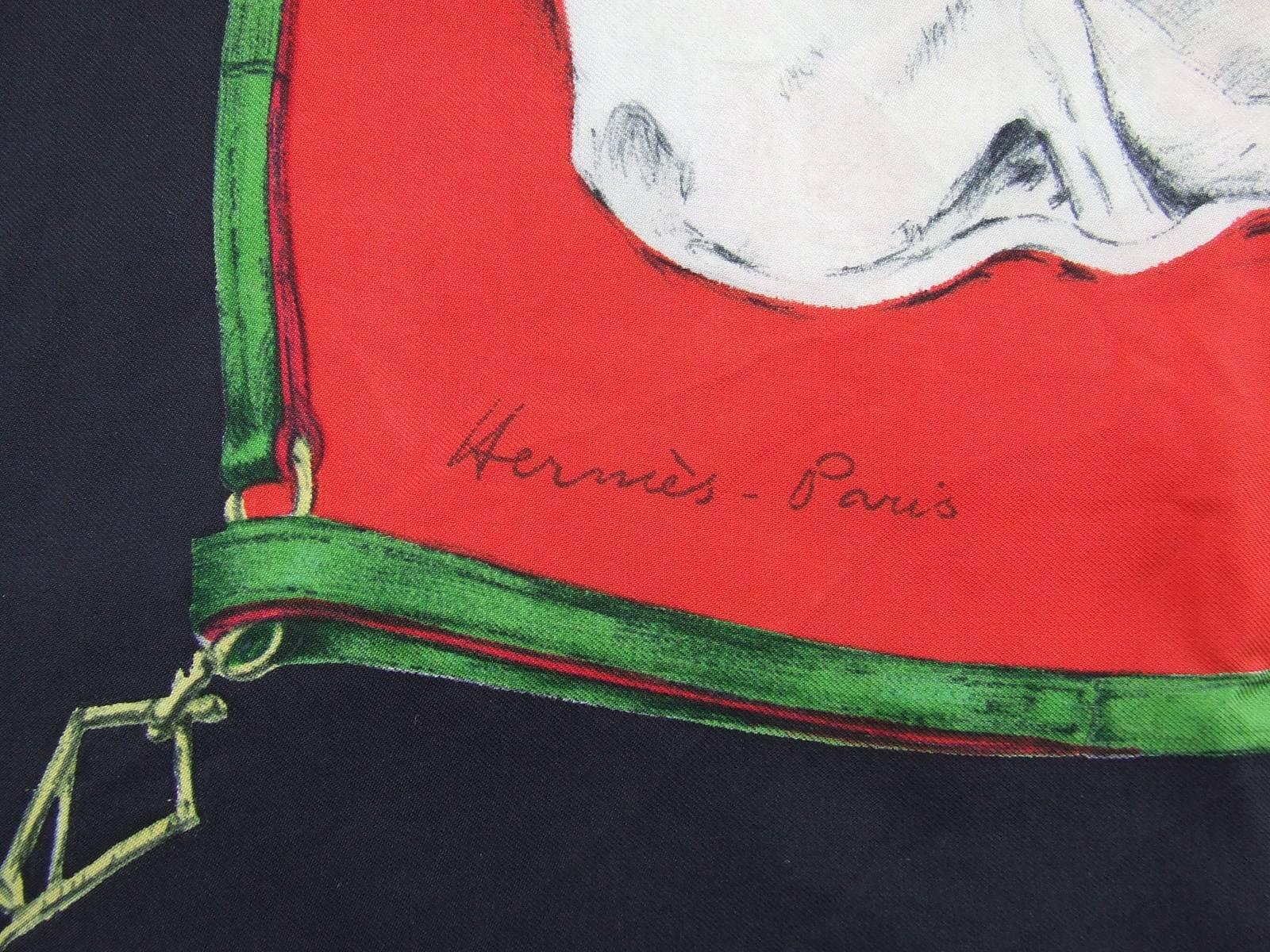GORGEOUS AUTHENTIC HERMES SCARF

 
Pattern: LEVRIERS (Greyhounds)

Made in France

Design by Xavier De Poret in 1956

Made  of 100% Silk

Colors: Black border, Red background, Beige and Grey Greyhounds with Green necklace

Measurements: