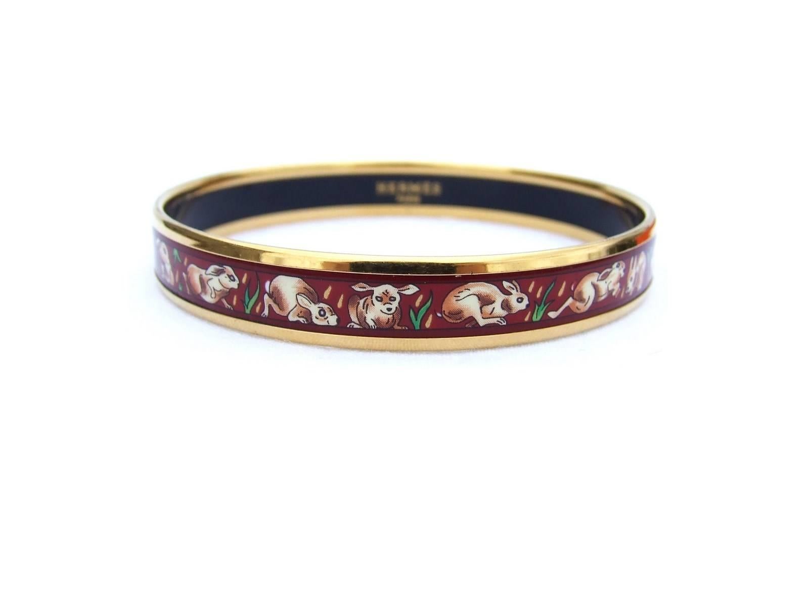 SO CUTE AUTHENTIC HERMES BRACELET

Pattern: Rabbits in the grass

Made in Austria + C

Made of Printed Enamel and Gold Plated Hardware

Colorway: Deep red background, Beige and Brown Rabbits, Green Grass

