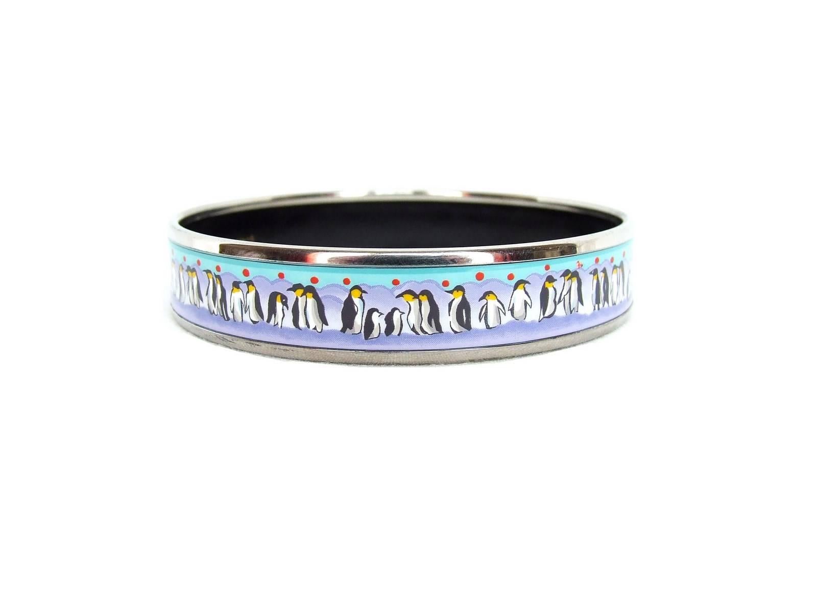 RARE AND BEAUTIFUL AUTHENTIC HERMES BRACELET

Patter: Penguins on Ice

Made in Austria + E

Made of Printed Enamel and Palladium Plated Hardware (silver-tone)

Colorways: Purple ice and background, Turquoise blue Sky with Red polka dots,