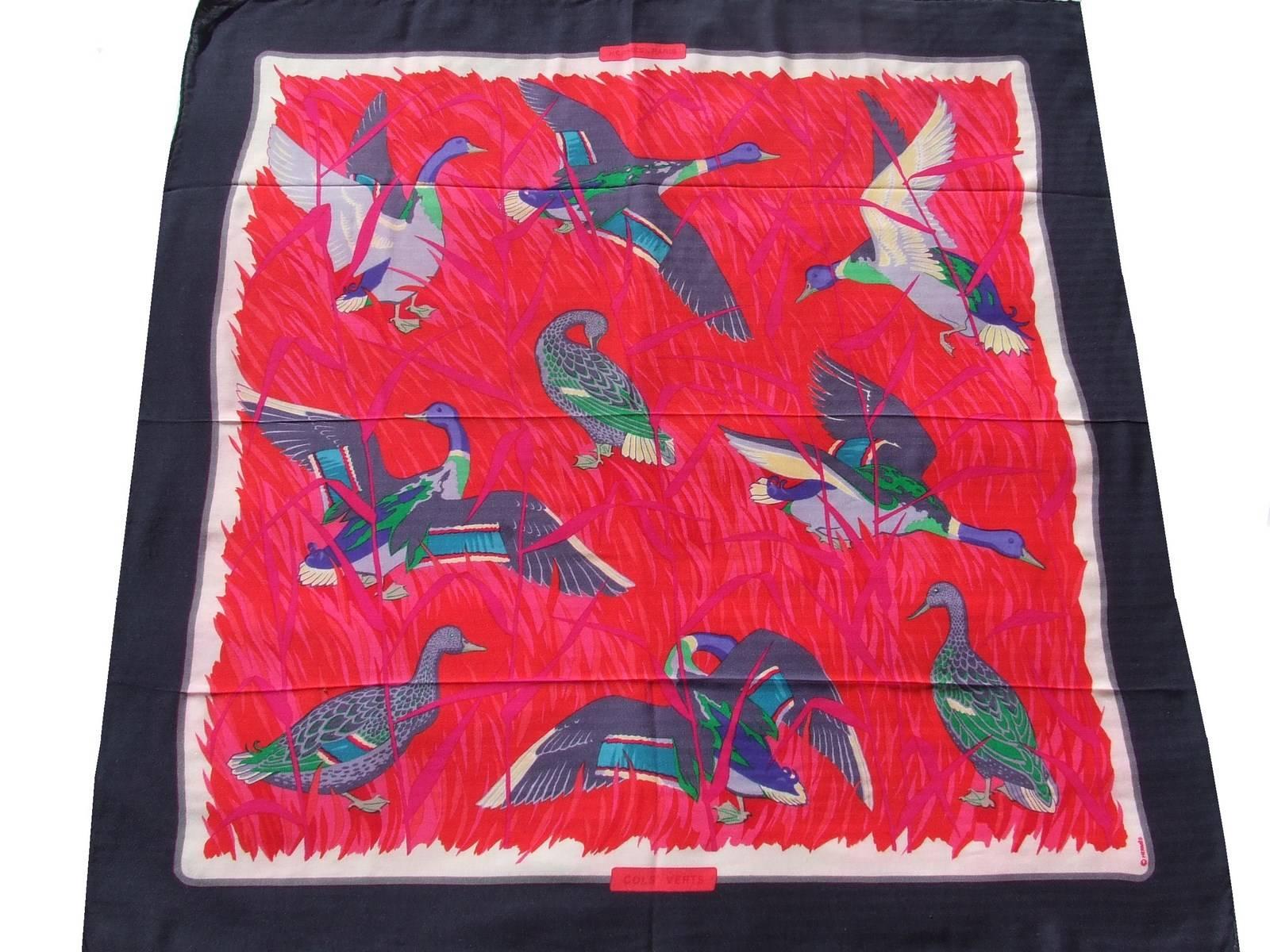 Beautiful Authentic Hermes Scarf

Pattern: Cols Verts

Made in France

Designed by Christiane Vauzelles in 1973, reissued in 1990

Made of 65% Cashmere and 35% Silk

Colorways: Navy Blue Border, Red and Pink Background, shades of Purple,