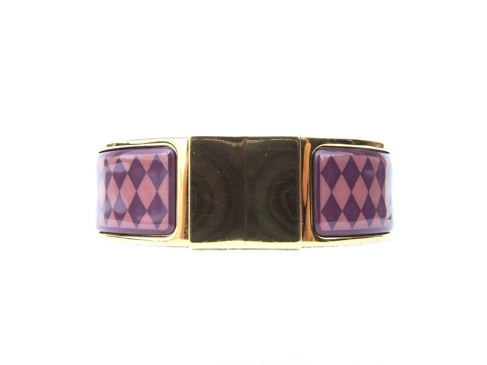 Gorgeous Authentic Hermes Bracelet

"Clic Clac" version

Stamp D

Made of Enamel Printed and Gold plated Hardware

Pattern: diamond-shaped

Colorways: Old Pink and Purple

"HERMES" and gold plated symbol engraved inside

Size: