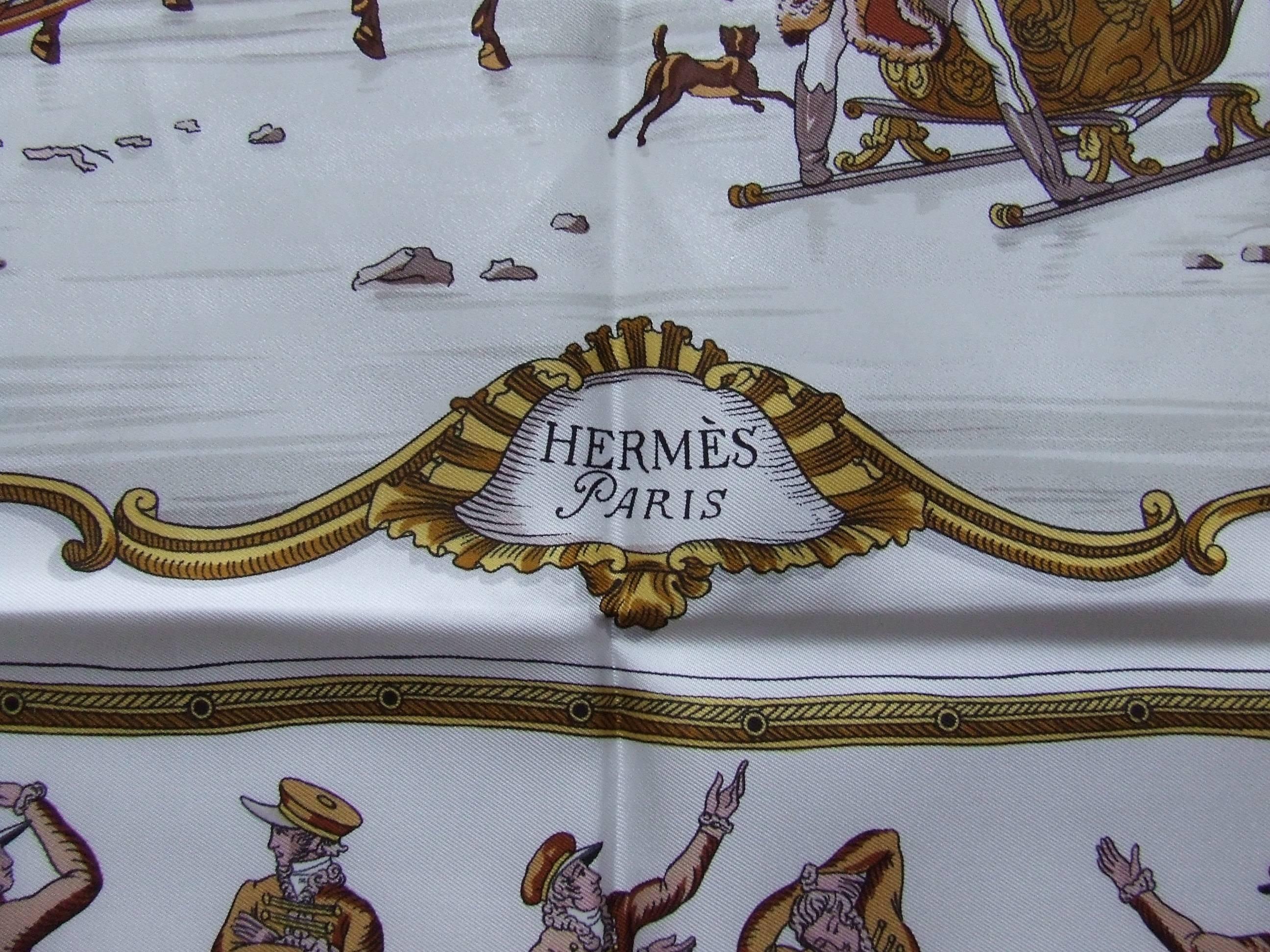 Beautiful Authentic Hermes Scarf 

Pattern: "Les Plaisirs Du Froid"

Designed by Hugo Grygkar in 1948

This one is a reissue from 1997

Made in France

Made of 100% Silk

Colorways: White Background, Gold Orange Yellow Brown Pink