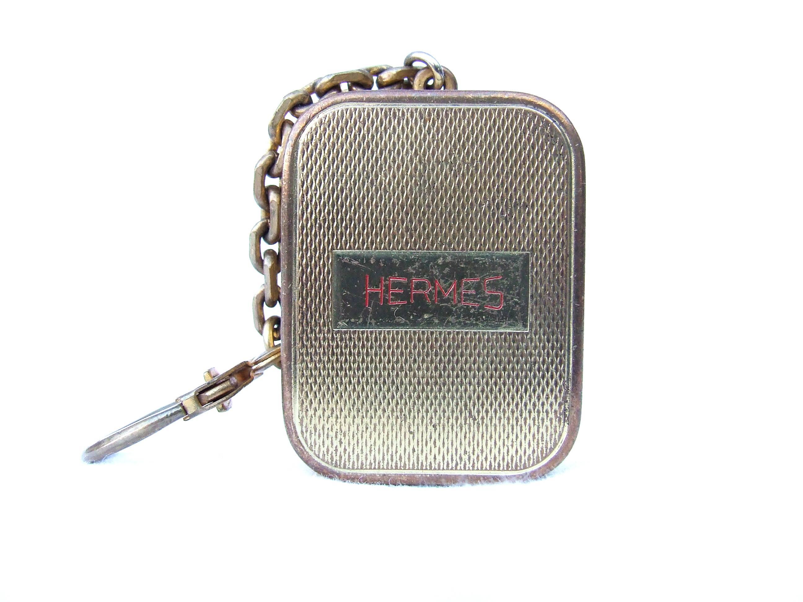 Rare Authentic Hermes Keychain

It is also a music box !

Turn the mecanic key (at the back) clockwise and go up the small button to hear the music 

Made by Reuge, seller of music boxes, located in Sainte Croix, Swiss

"HERMES" in red