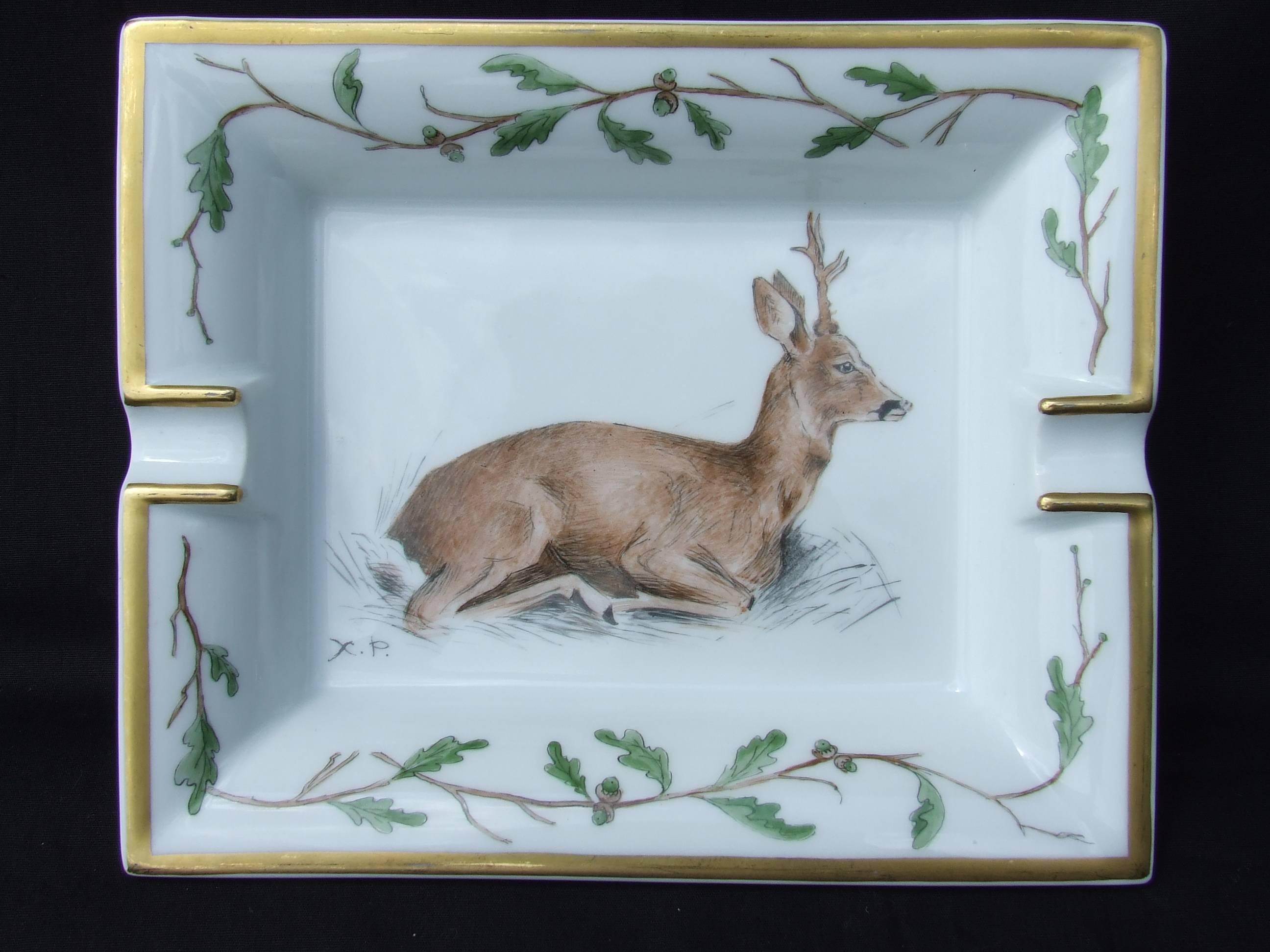 Rare Authentic Hermès Ashtray

Pattern: Deer in a setting of oak leaves and acorns

Made in France

Made of Printed Porcelain of Limoges 

Colorways: White Background, Light Brown Deer, Green and Brown oak Leaves, Golden Border. 


