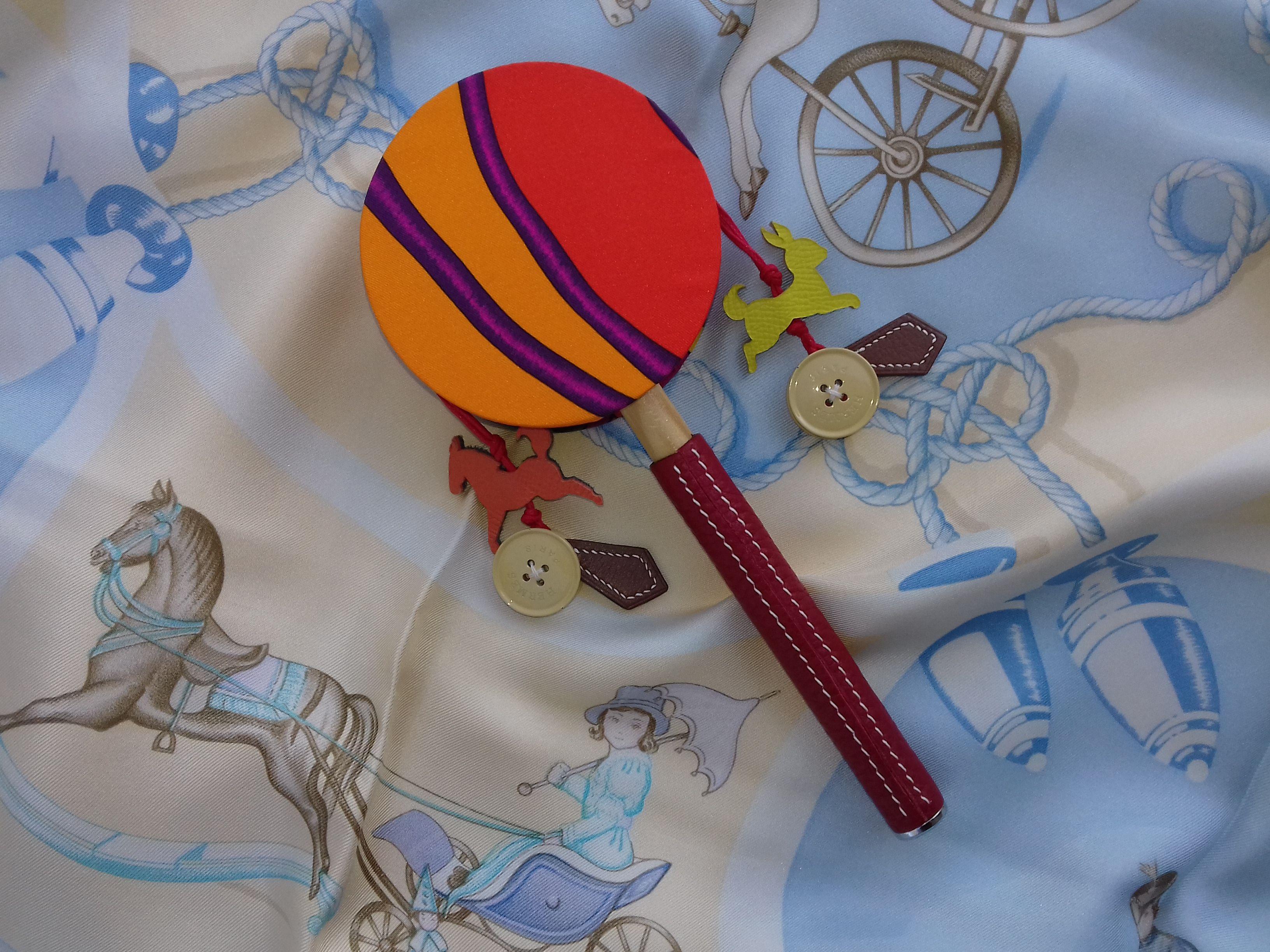 Authentic Hermès Tambourine

Cutest rattle ever !

Made of Silk, Leather and Wood

Colorways: Mainly Orange and Pink

Made for the 2016 Hong Kong Mid Autumn Festival 

