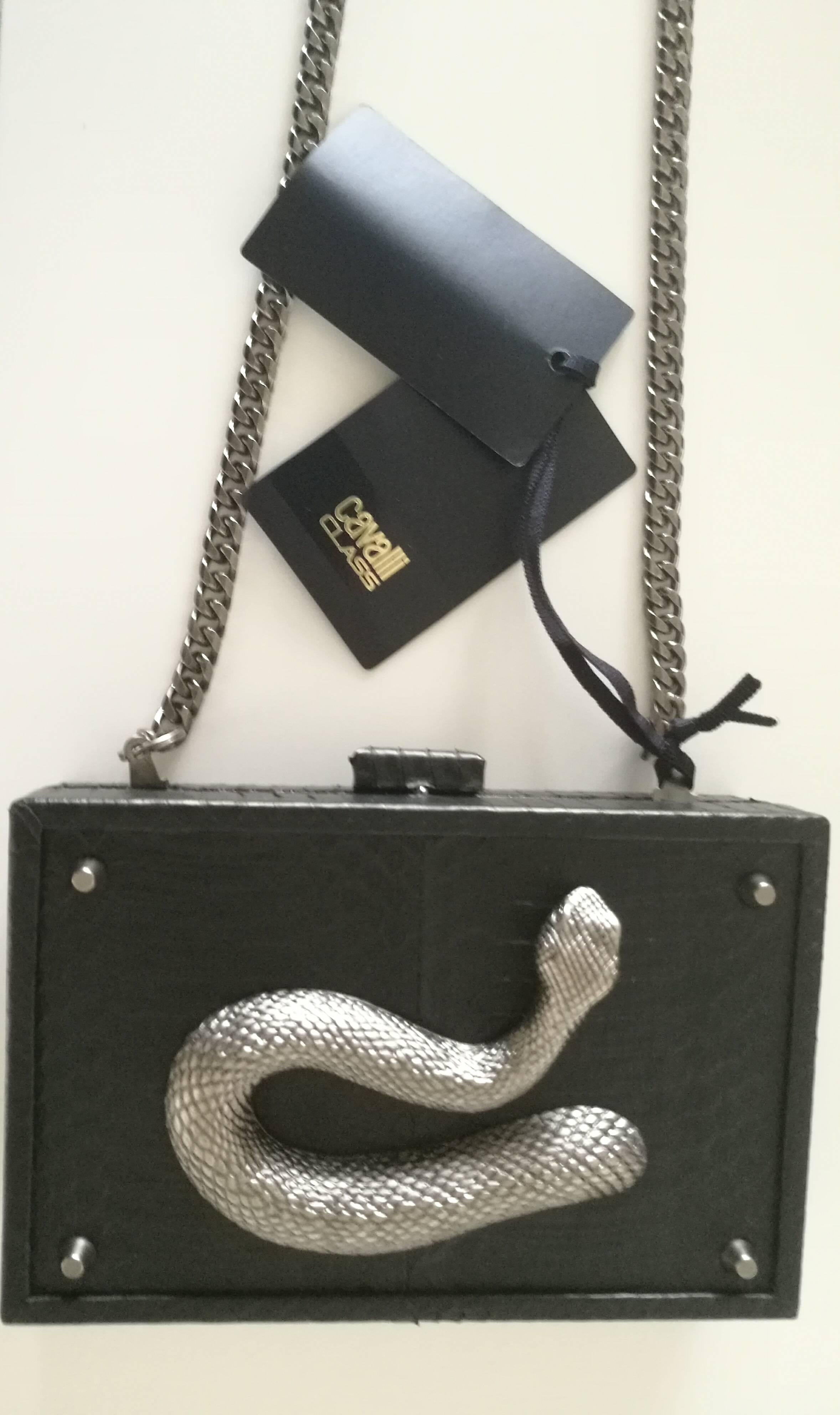 Roberto Cavalli Class Black Snake Skin Clutch NWOT

Silver hardware and silver tone chain with snake on the front 
Still with tags
