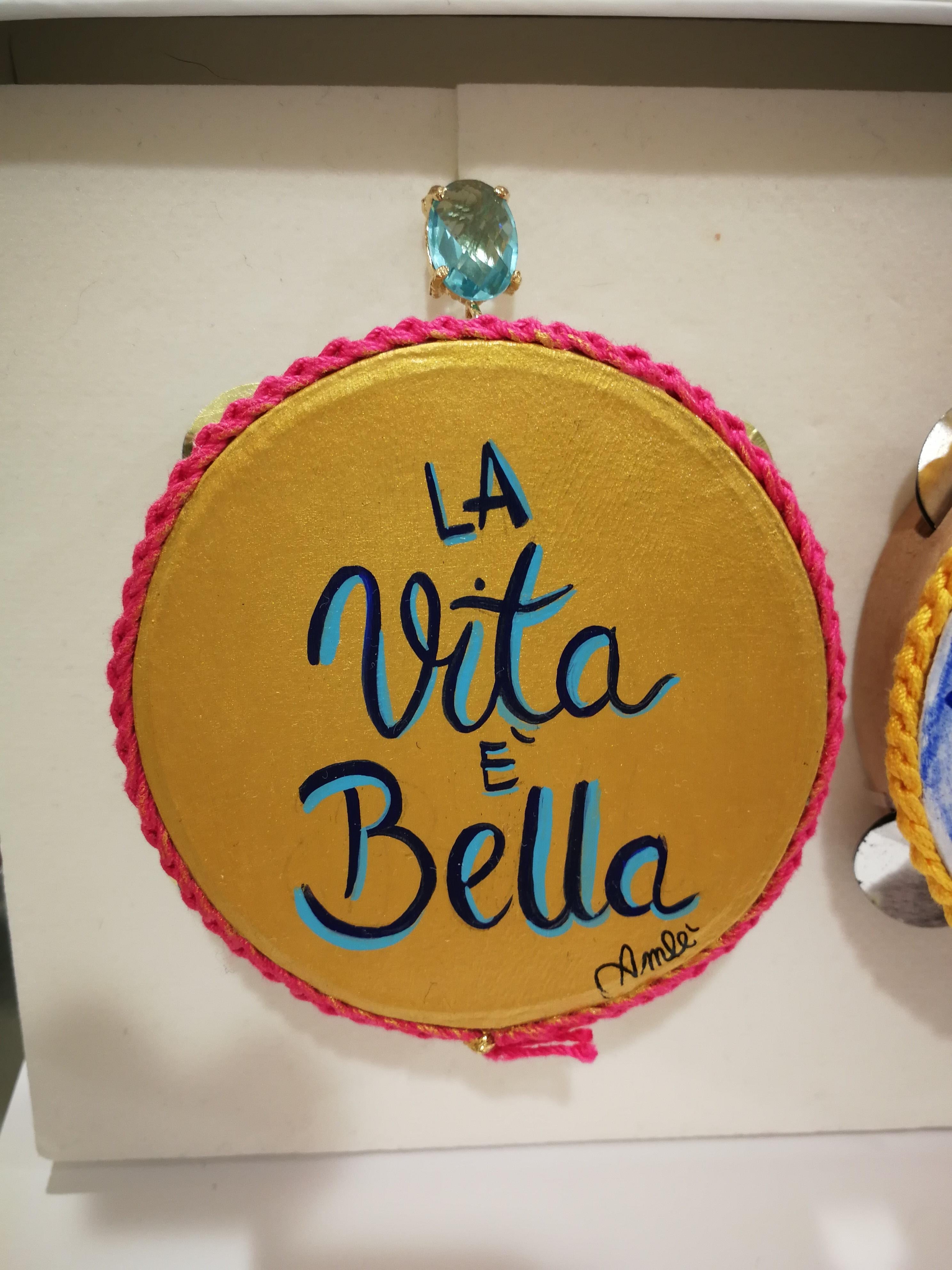 Amlé Life is Beautiful Handmade Tambourine Earrings

Handmade and handpainted tambourines
one La Vita è bella (Life is beautiful) the other inspired to vietri sul mare, italy-
embellished with precious stones and finished with the frame in 925