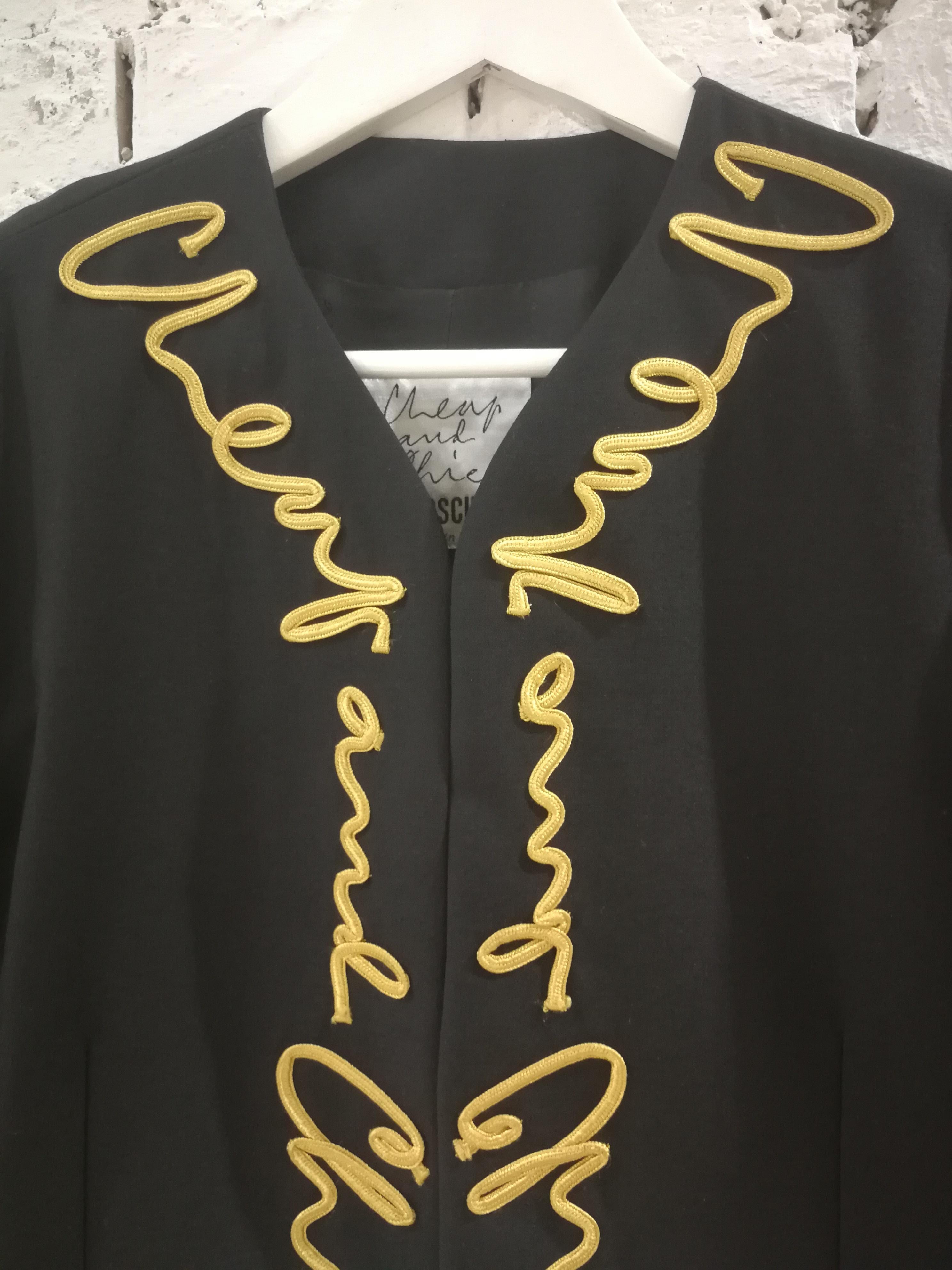 Moschino Cheap & Chic Black Gold Jacket
Unique and really hard to find Moschino Black and gold written jacket
totally made in italy in size 44
Composition: Wool
Measurements: 
total lenght 45 cm
shoulder to hem 62 cm 
