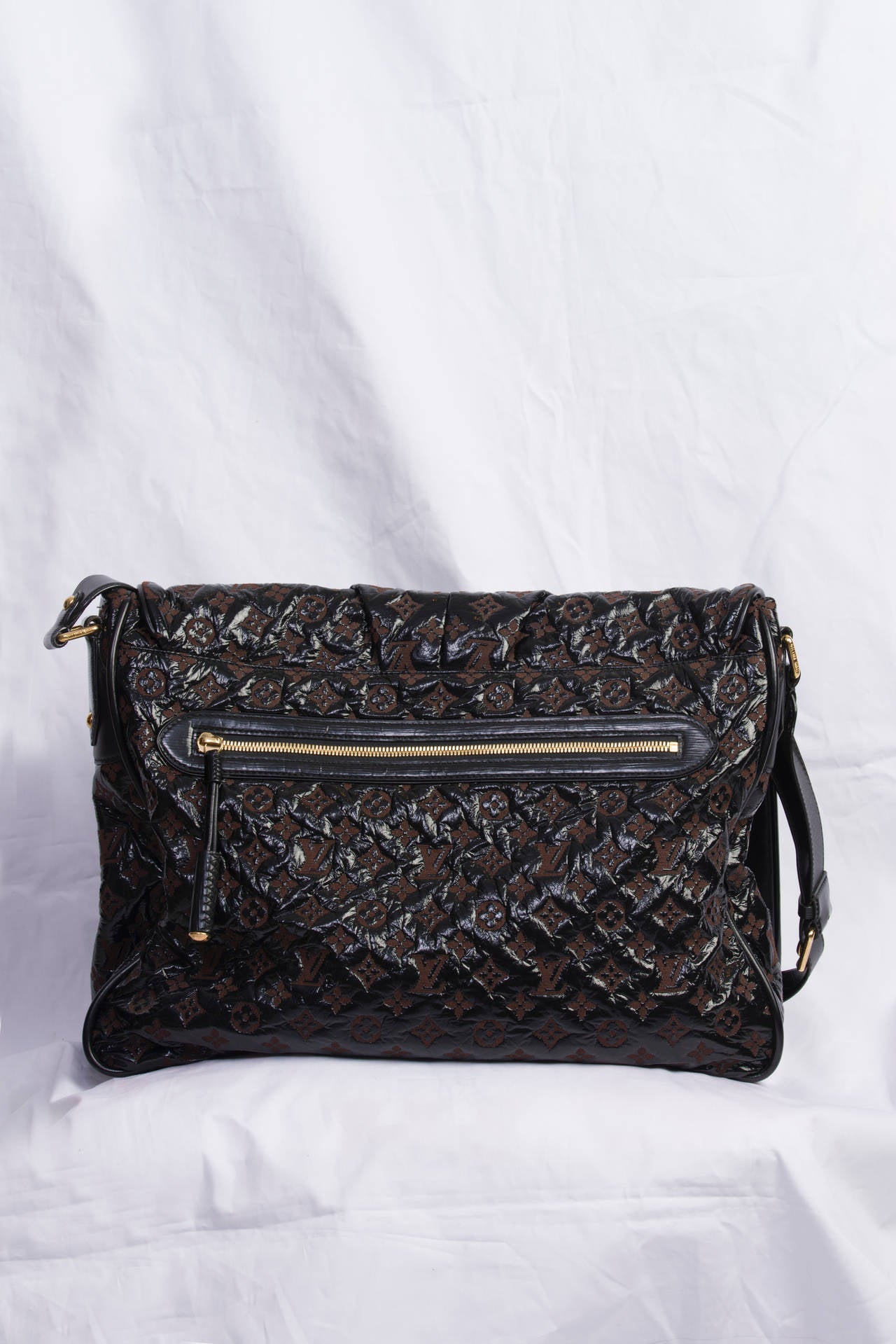This is an authentic LOUIS VUITTON Vinyl Monogram Squichy, also called Squishy, Inventeur Messenger Bag in Black. This stylish shoulder bag is crafted of soft and durable vinyl with an embossed Louis Vuitton monogram. The bag features a long leather