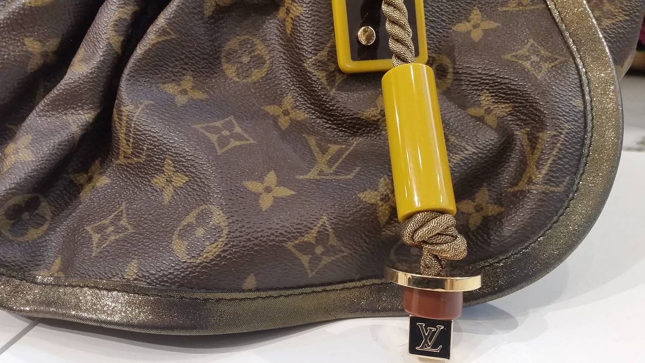 2009 Louis Vuitton Kalahari bag
Monogram Kalahari GM shoulder Bag. Leather has developed into honey patina. 

As seen from Louis Vuitton’s Spring/Summer 2009 show in Paris back in October 2008, the emblematic Kalahari named after the famous
