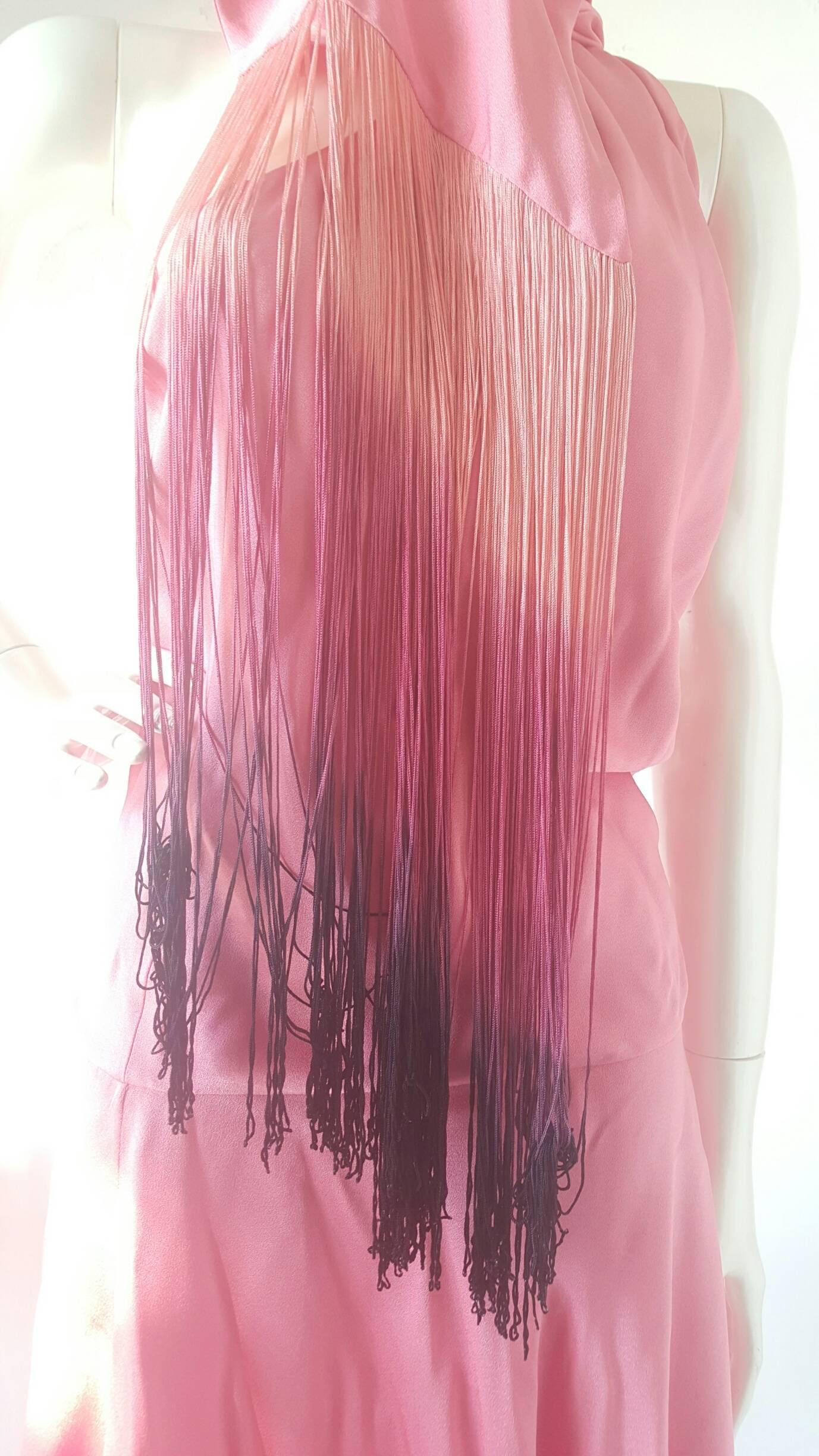 ABITO ALEXANDER MCQUEEN PINK DRESS 
NEW WITH TAGS

Fucsia silk dress with long wrap around scarf trimmed with ombre dyed fringe from Alexander McQueen dating to 2007. Labeled an Italian size 42, which best fits a US size 6. Zip entry at side with