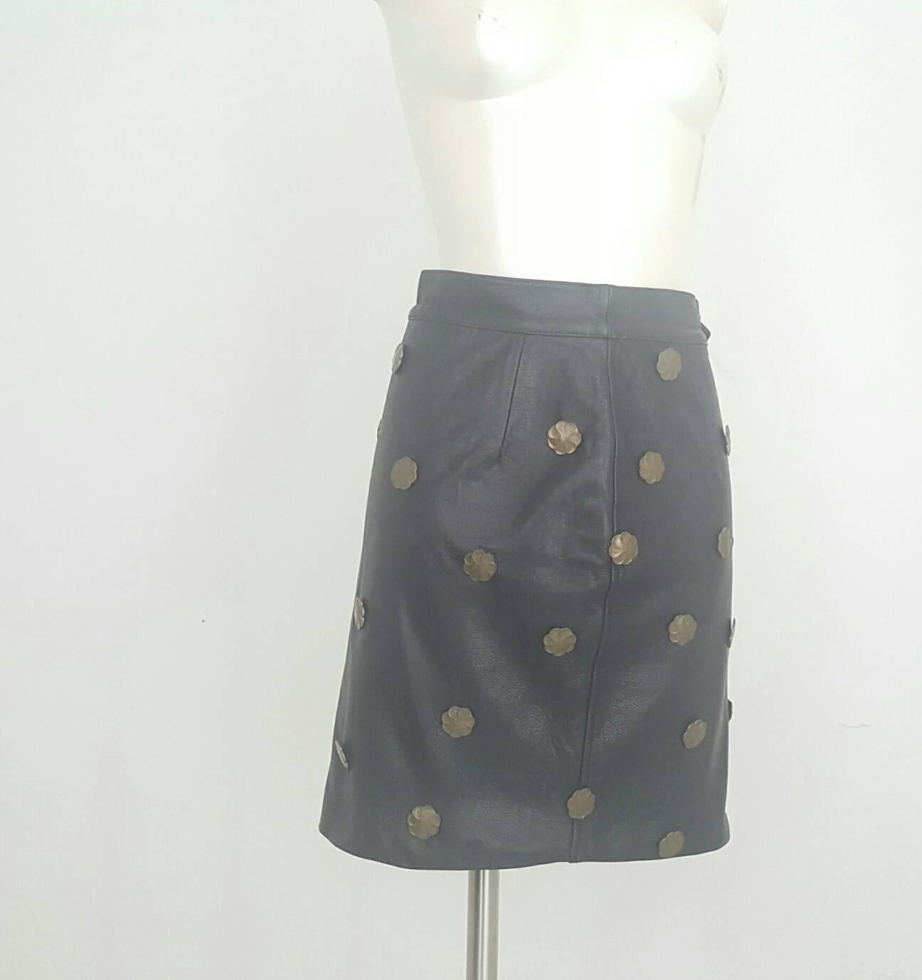 1980s Moschino black leather skirt with brass gold flowers. 
No laber attached but size is 42 or 44 italian size range. 
Composition 100% Leather