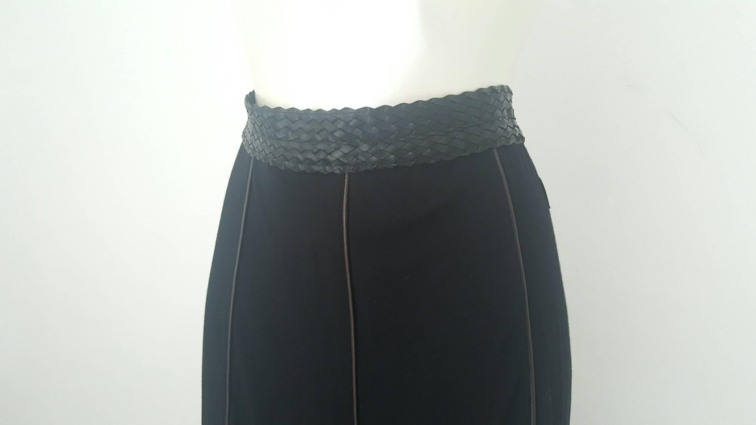 1990s Moschino jeans black skirt with leather belt and details in italian size range 46
composition: 96% viscose 4% elastane