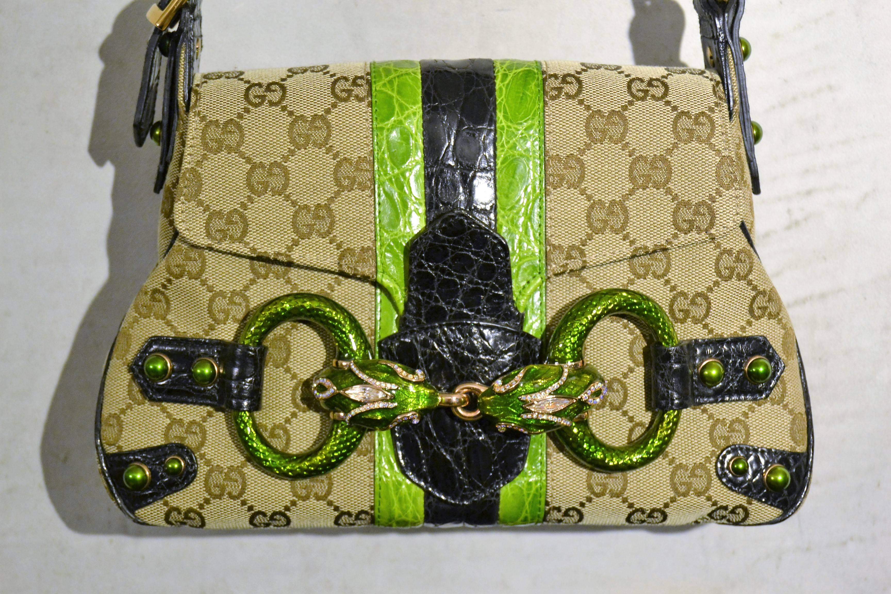 1990s Gucci monogram python skin bag

Unique, rage amazing bag by Gucci
in monogram and python green skin with snakes on the front covered with real swarovski
