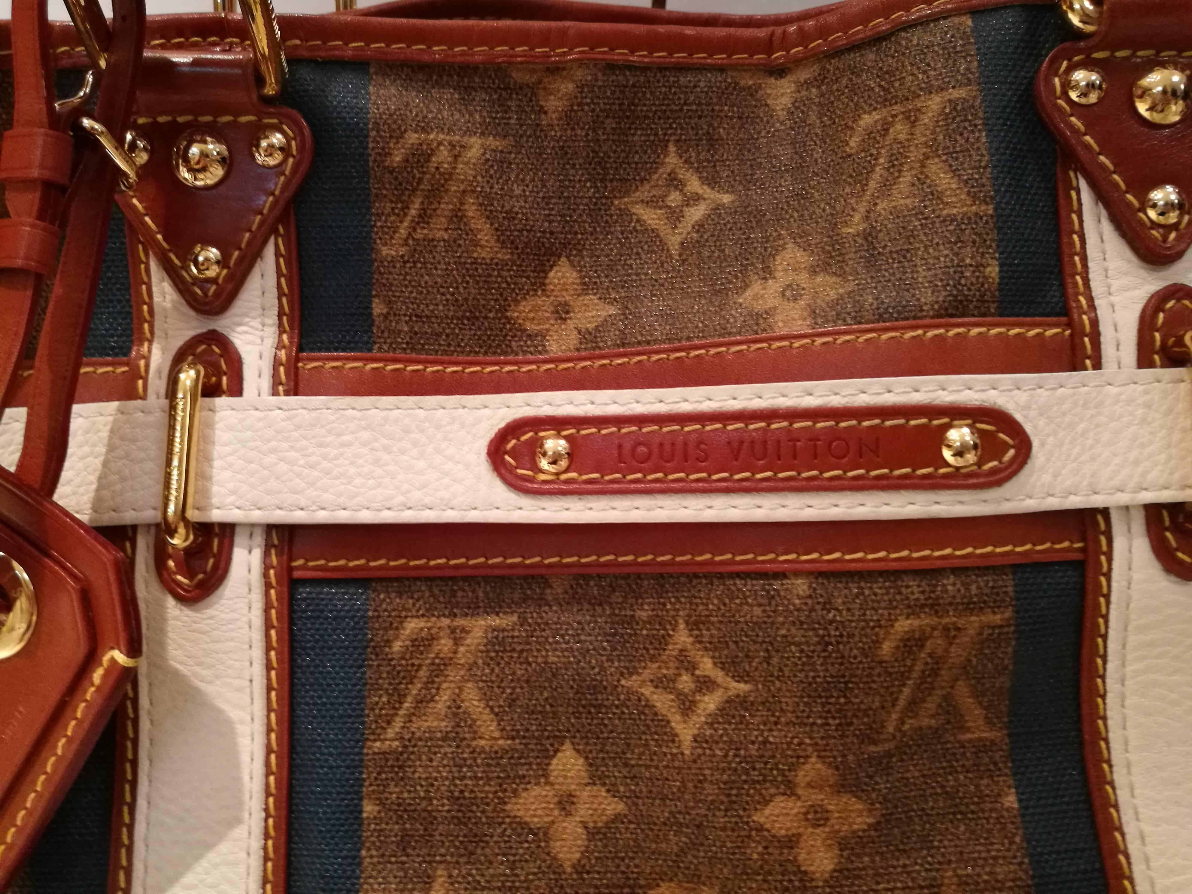 This is an authentic LOUIS VUITTON Monogram Tisse Sac Rayures GM Blue. The unique style and sophisticated features of this Louis Vuitton shoulder bag have a chic look of elegance for everyday. 
The bag is the largest size of the Sac Rayures and