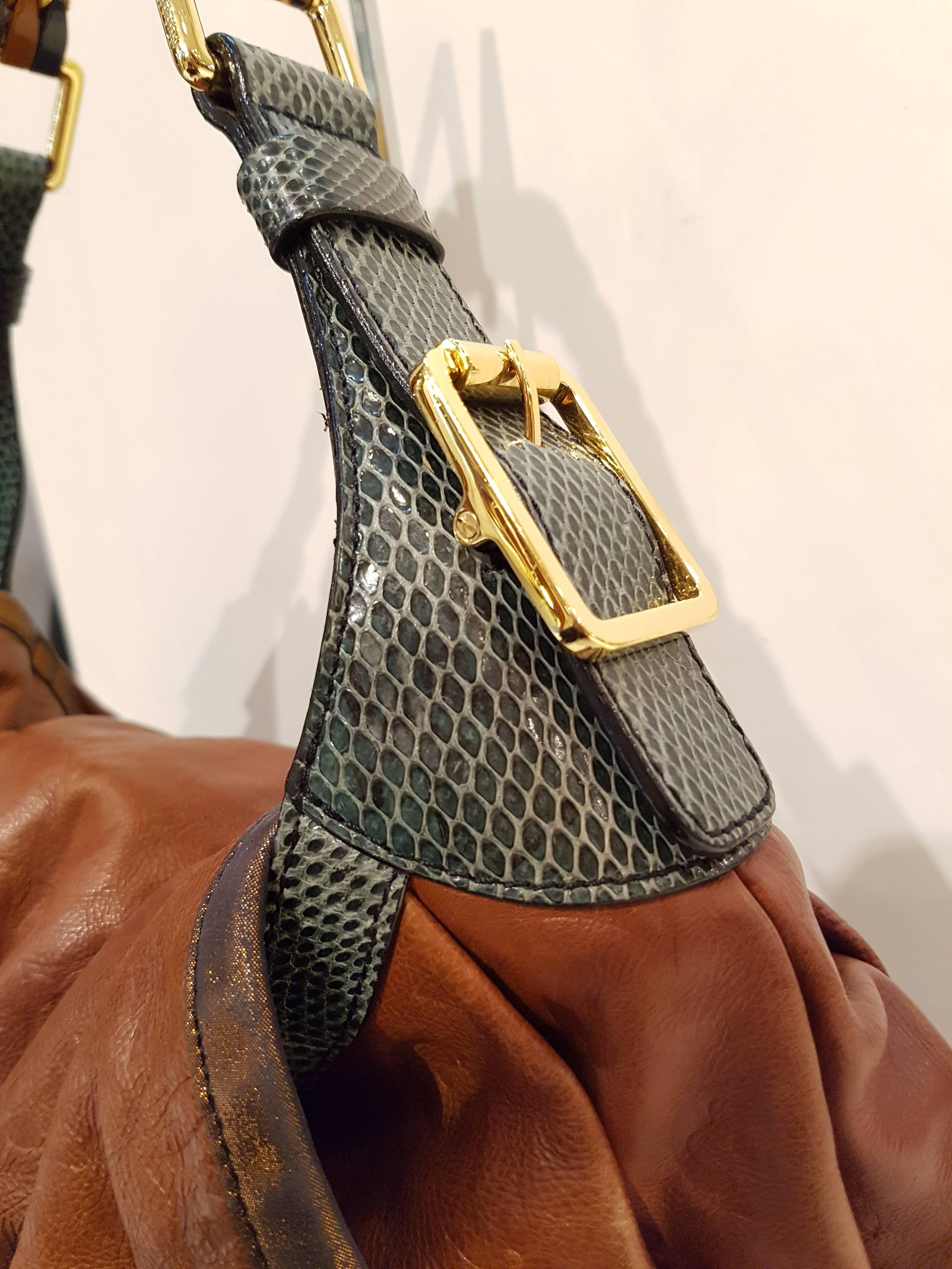 LOUIS VUITTON Monogram Epices Kalahari GM Masala 
 This stylish shoulder bag is crafted of caramel colored monogram embossed leather. The many features of this bag are a looping shoulder strap of green python and brass and stone beads, brass