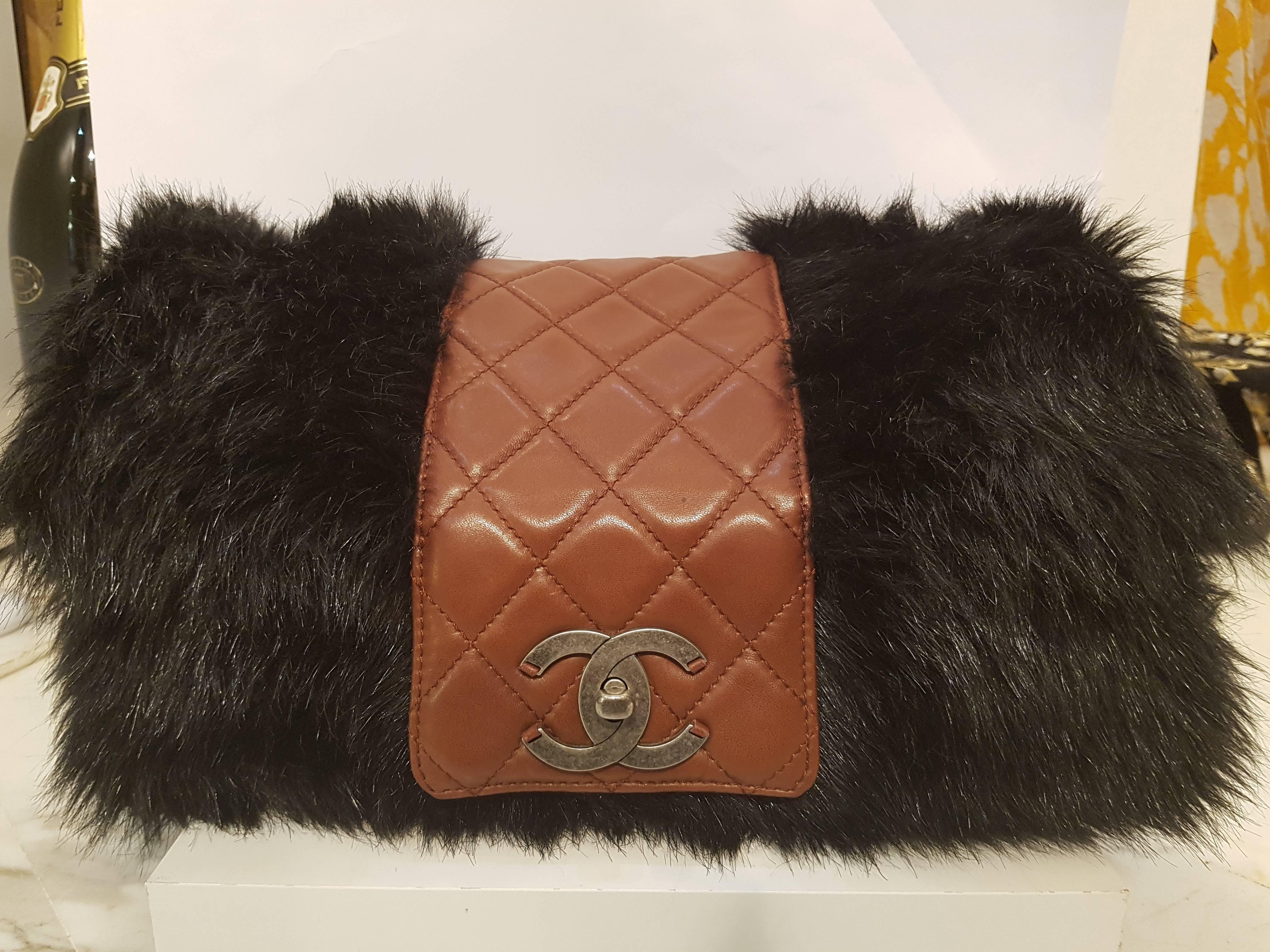 CHANEL Fantasy Fur Arctic Flap 
This stylish flap bag is beautifully crafted of black faux fur. The bag features bronze chain link shoulder straps threaded with brown leather and diamond quilted chocolate colored leather on a frontal flap with a