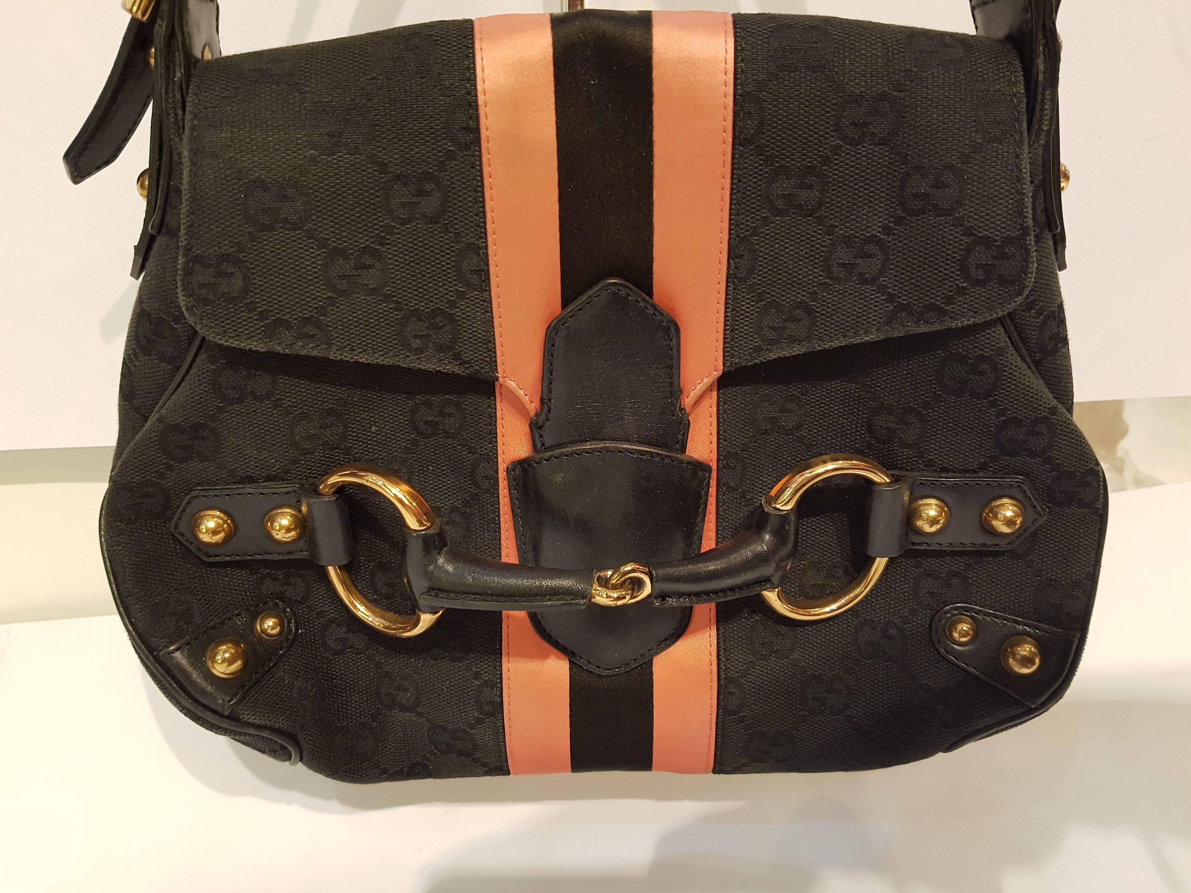GUCCI Monogram Horsebit Web Flap Bag Black Pink 
The unique features and exceptional quality of this Gucci evening bag create a bold look of sophistication for evening. The bag is a standard size evening bag and is a sturdy pouch structure of black