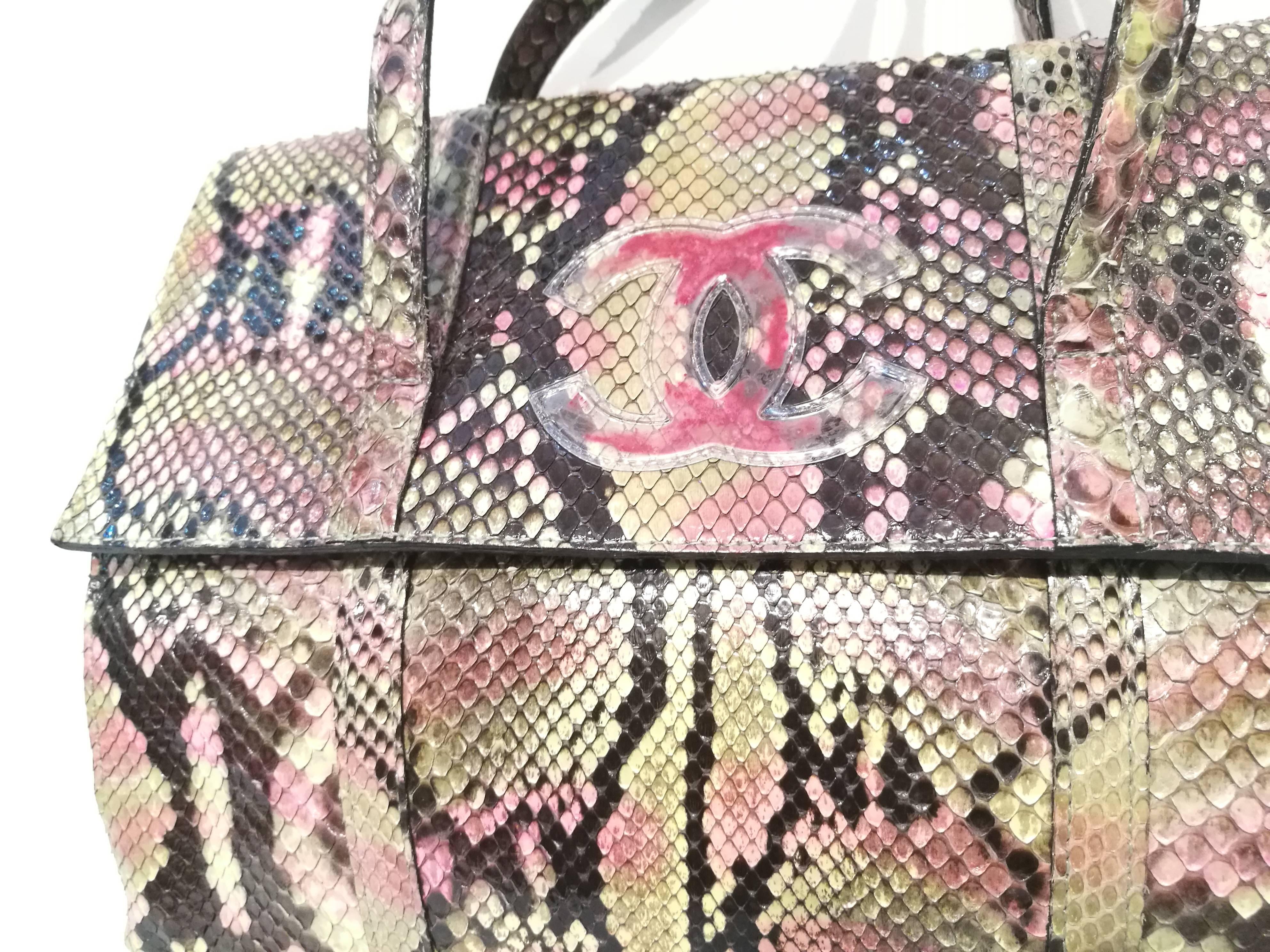 This vintage Chanel python bag features a multicolored python body with the signature CC stitched on the front and a convenient top handle.

Material: Python
Color: Multi
Condition: Excellent
Circa: 1997-1999