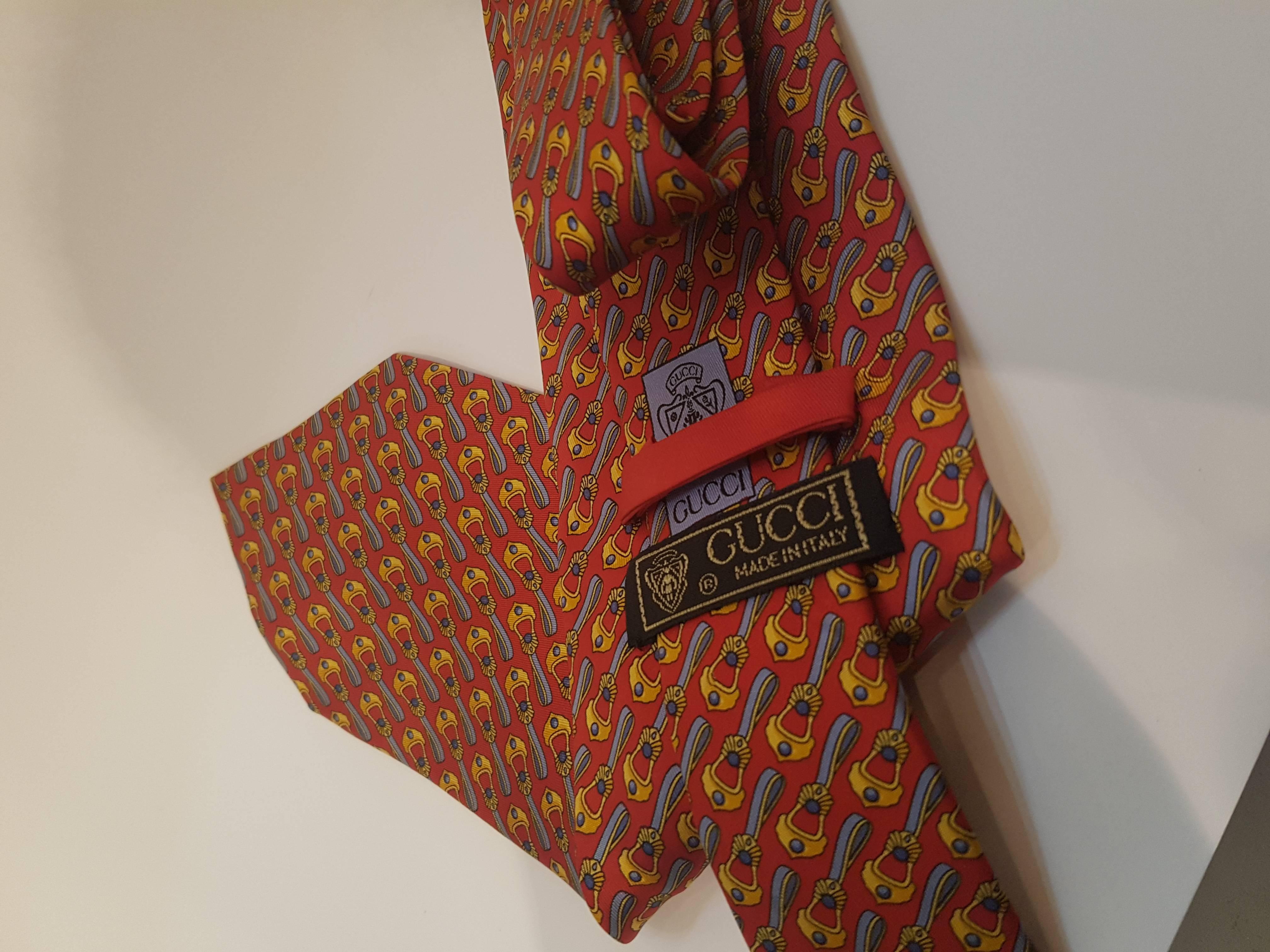 Gucci red tone with multicolour designs on it vintage tie
totally made in italy in 100% silk