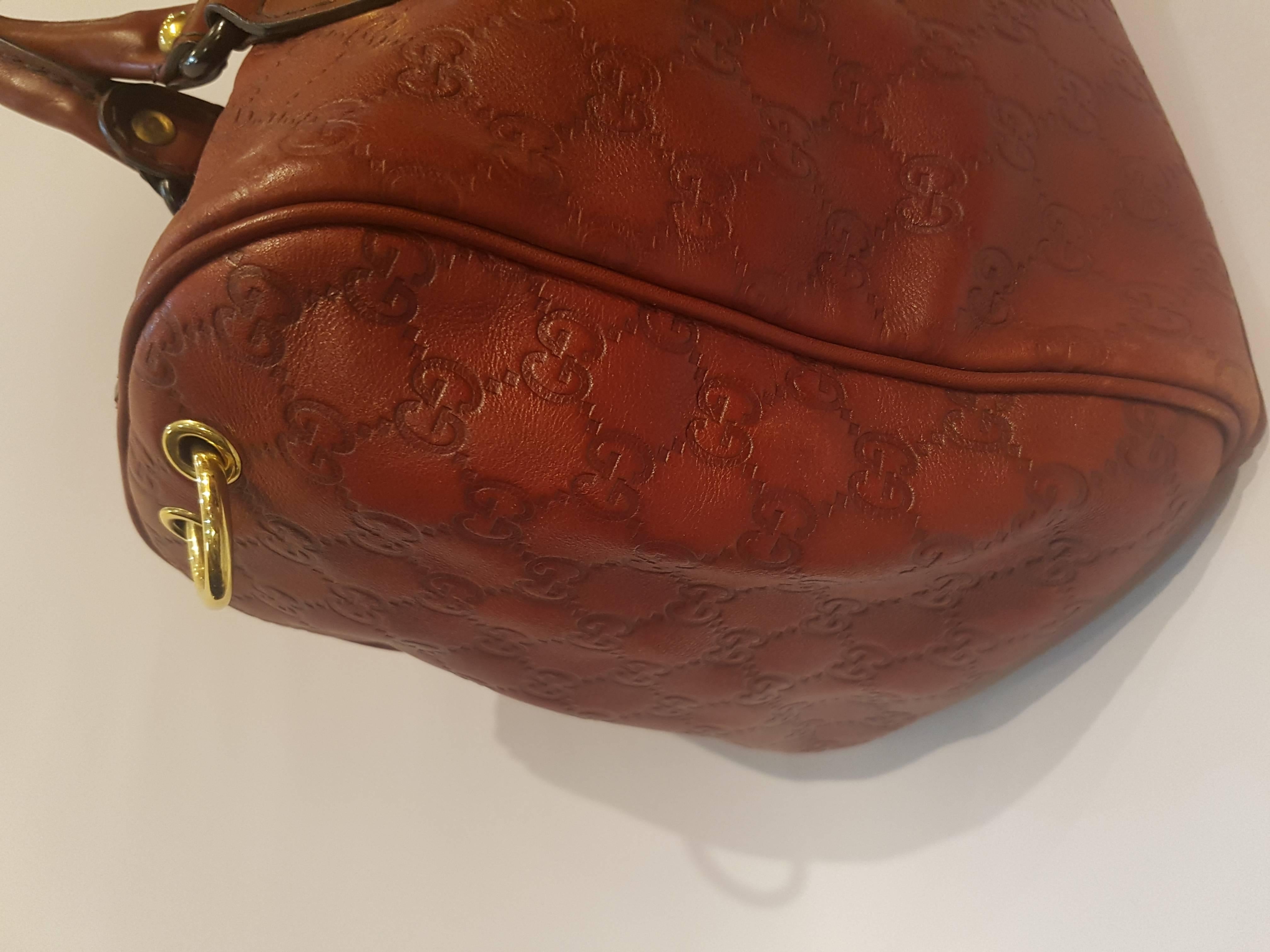 Gucci Babouska Boston Bag
Gucci red tone leather with studs and hardware gold tone studded heart.
