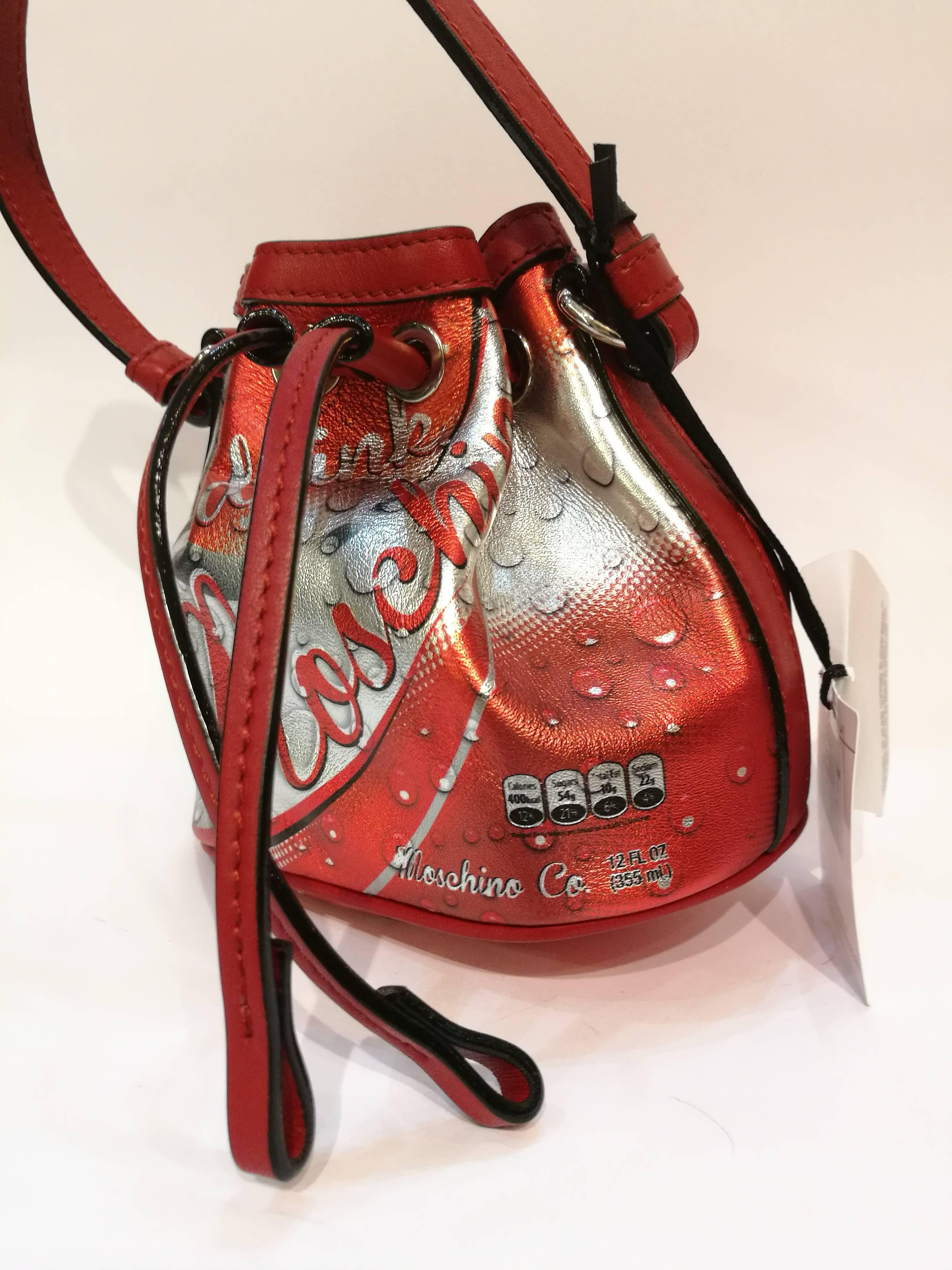 Moschino Red Coca Cola Satchel NWOT
Drink Moschino small leather bag made from 100% sheepskin. Coca Cola design in red / silver color. Bag has a removable shoulder strap. Ideal for combination with Drink Moschino mobile phone case, of course also