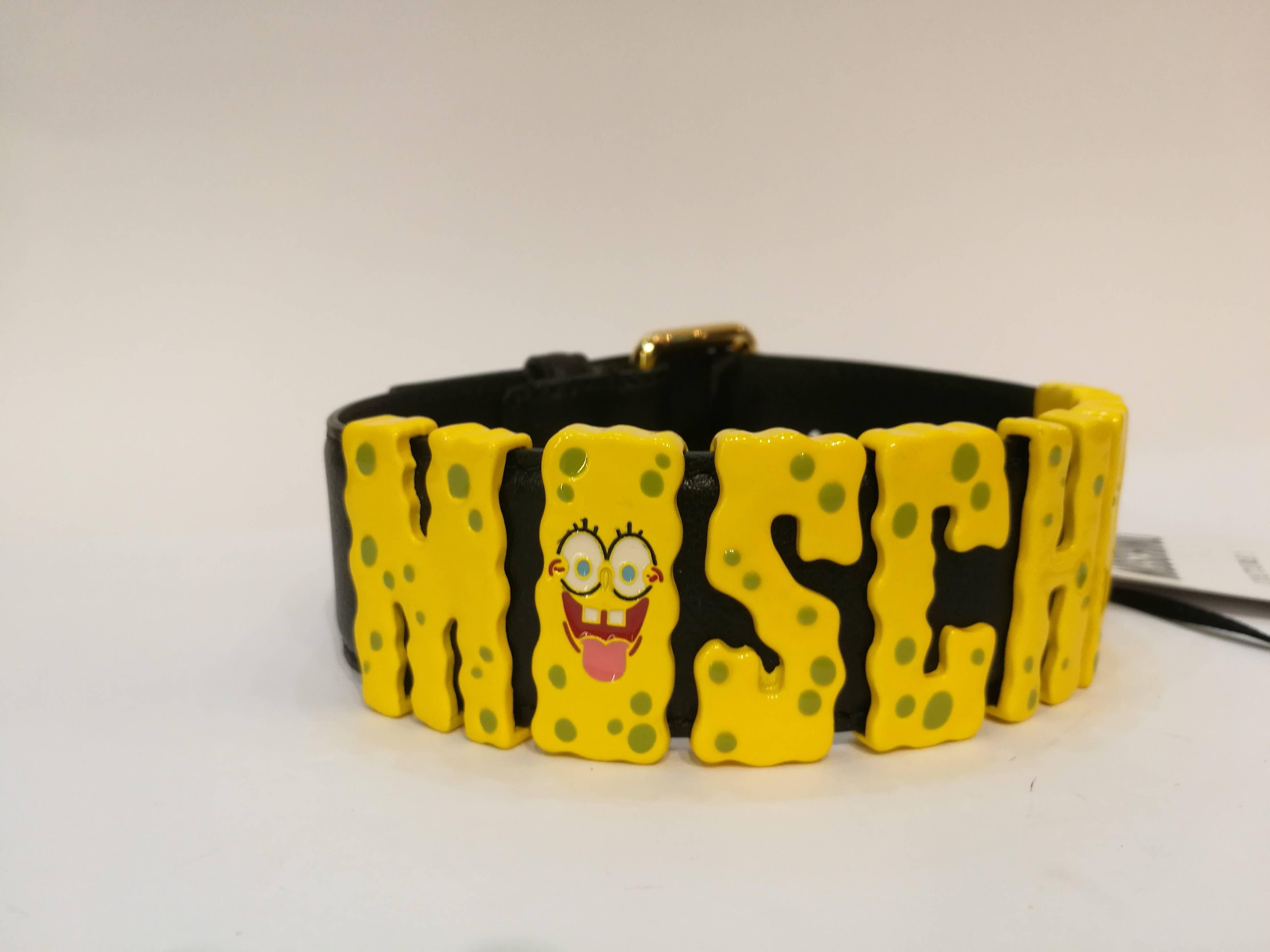 Black calf leather chocker  from Moschino featuring yellow SpongeBob logo plaque at the front and a stud fastening.
Made in Italy