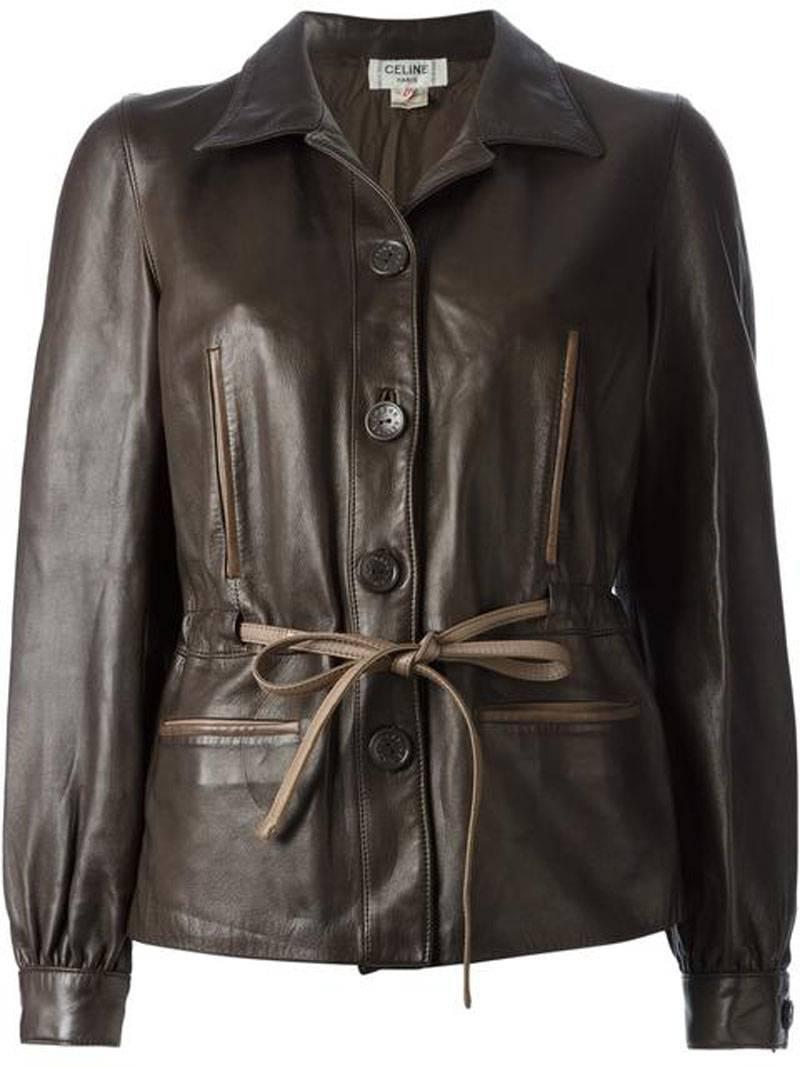 Brown leather tie waist jacket from Céline Vintage circa 1970 featuring a spread collar, two chest pockets, a front button fastening, front welt pockets, long sleeves and fitted cuffs.
