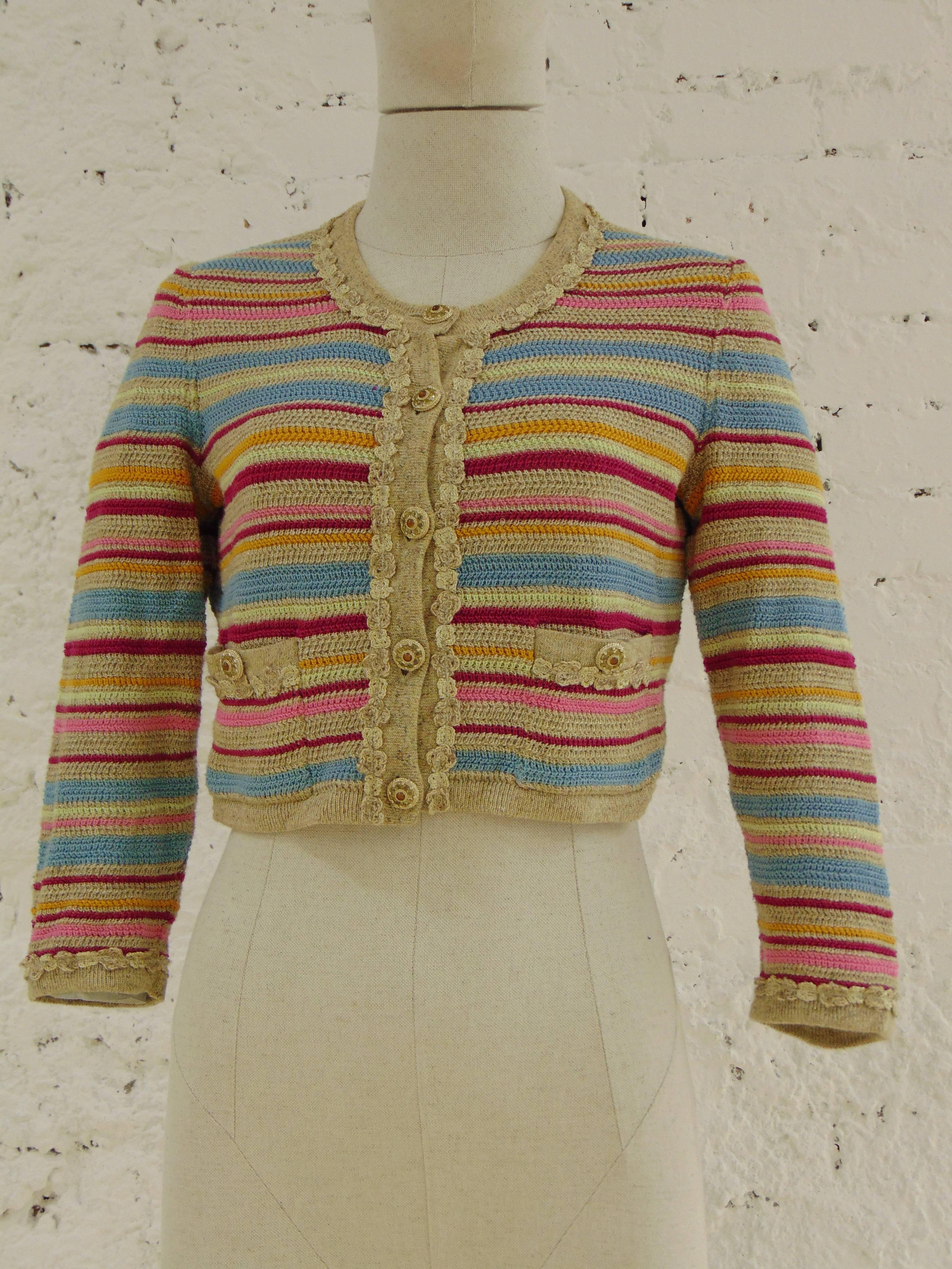Chanel multicoloured cotton cardigan

Beije, light blu, fucsia and yellow multicoloured cardigan totally made in france in size 40 embellished with gold tone hardware with semi precious stones
