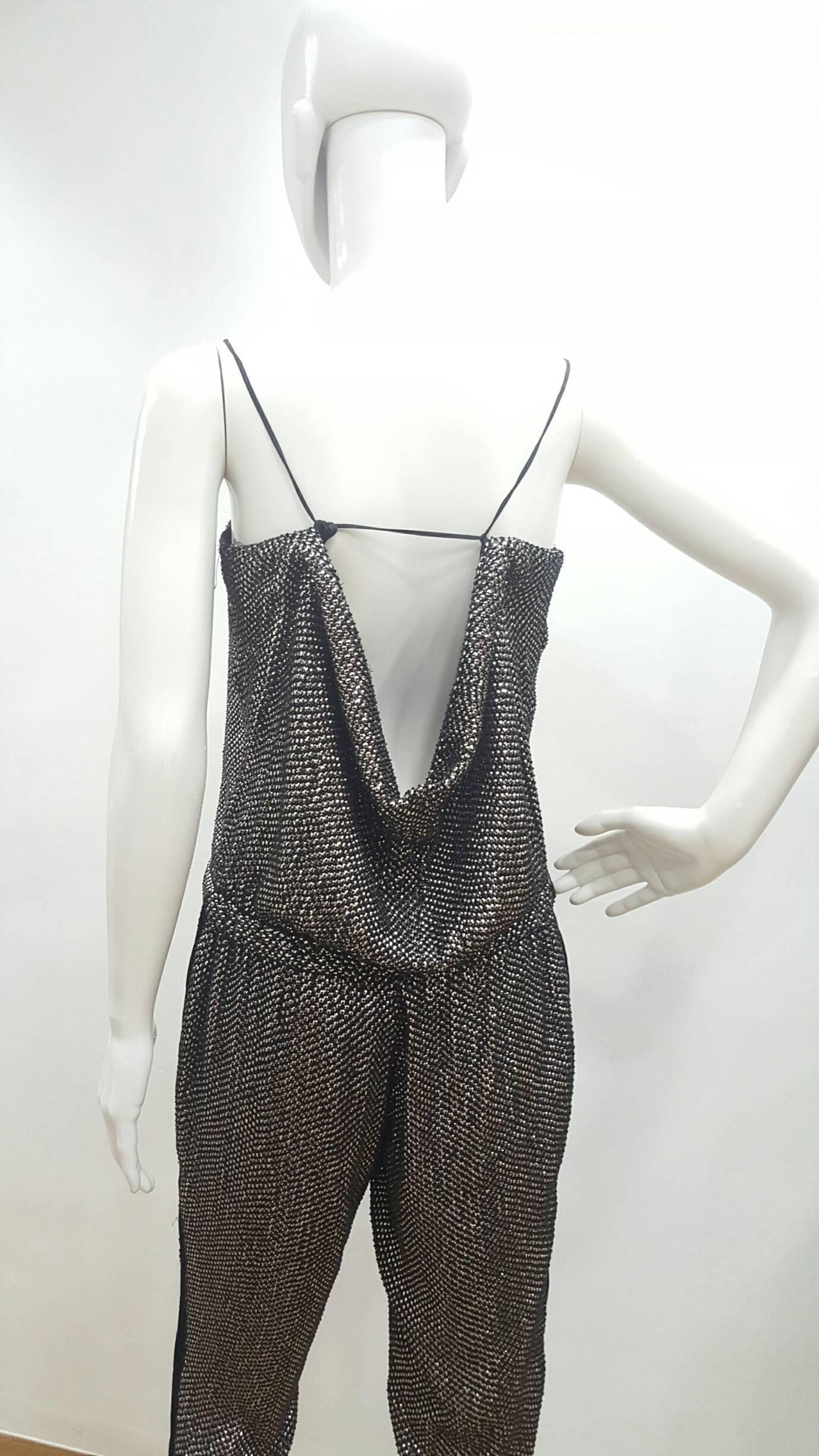 2000s Gucci All in one black with Swarovski crystals By Tom Ford
Already seen on Kylie Minogue 
Totally covered by Swarovski sequins and studs with pockets 
outlined with silk toulle 
Totally made in italy
in italian size range 38
Composition: