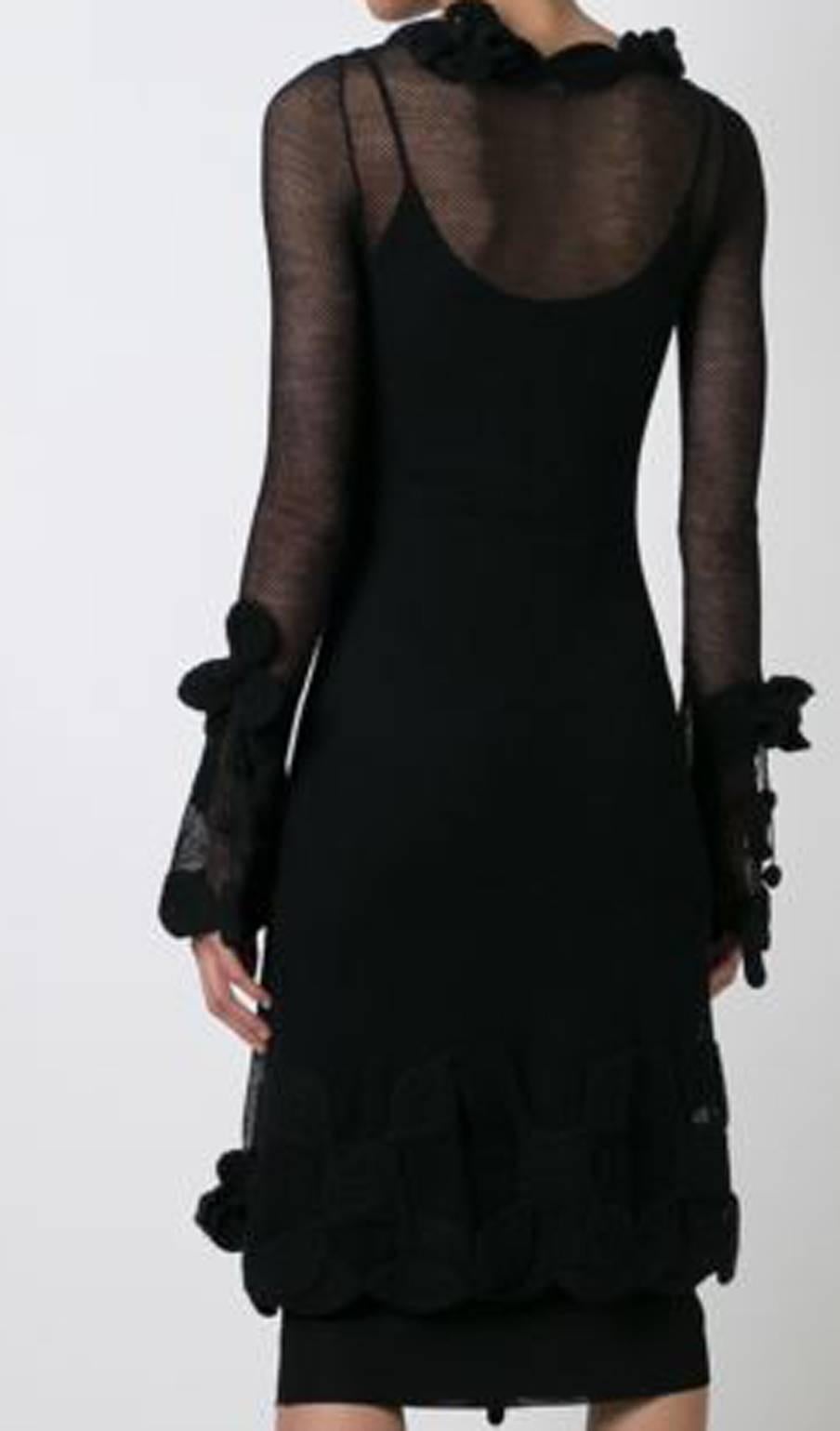 Rare Chanel black wool crochet mesh dress featuring a scoop neck, long sleeves, a fitted silhouette, a sheer construction, an asymmetric style, a hanging tassel, crochet flower details, a mid-length and a black silk Chanel slip dress. 
In excellent