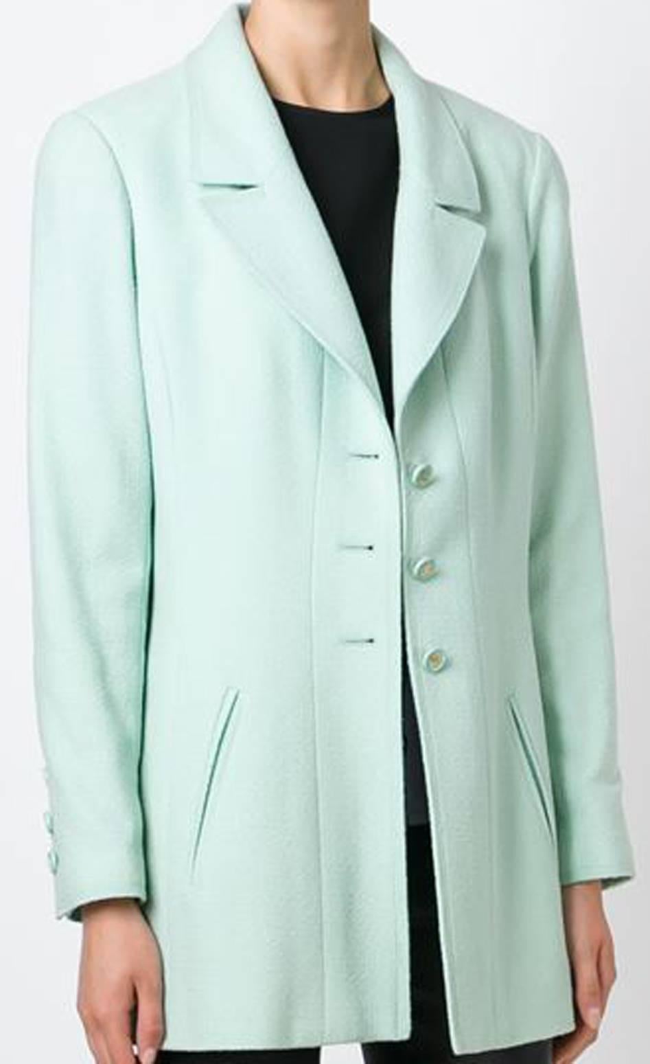 Chanel pastel green wool blend bouclé knit blazer featuring notched lapels, front logo button fastening, front welt pockets, long sleeves, logo button cuffs and a silk logo lining, and a gold-tone chain trim. 
In excellent vintage condition. Made in