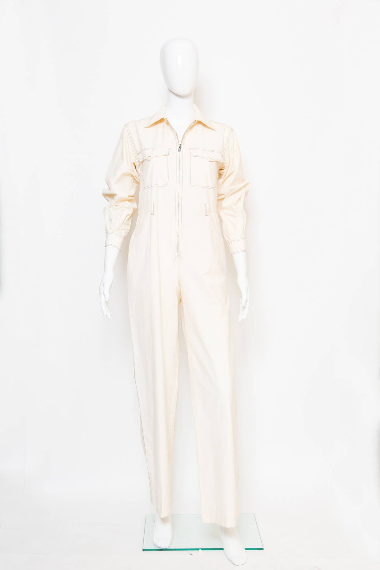 An iconic Yves Saint Laurent  sand cotton color jumpsuit, with black double stitchings, center front zipped, front & back pockets comes with seperated multistiched belt (90cm x 4cm).