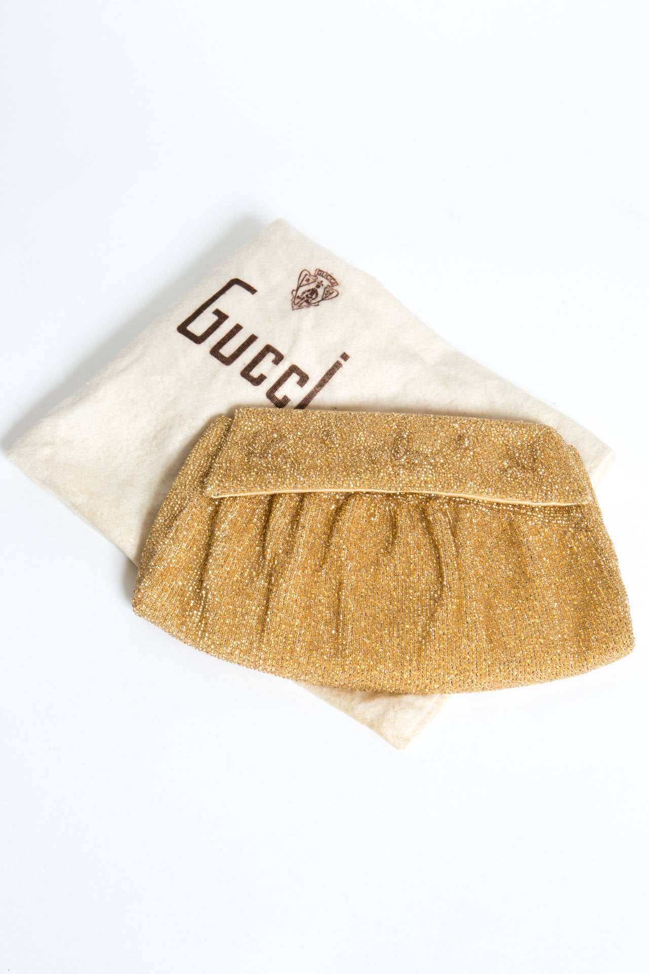 1970s Gucci rare evening clutch featuring gold-tone small beads, gets a front snap opening and an inside silk lining ,with a small pocket.
In excellent vintage condition. Made in Italy.
We guarantee you will receive this gorgeous clutch as