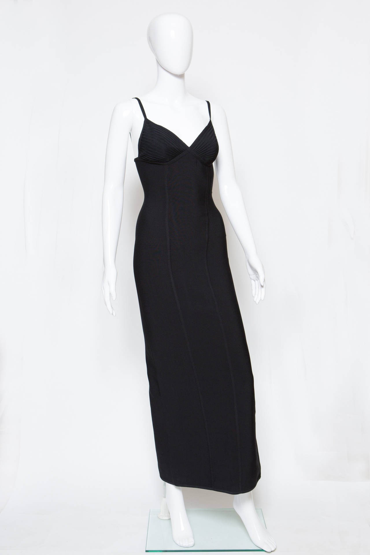 1990s Herve Leger black knitted dress designed by Herve Leroux featuring pleats on the chest, a center back slit, front  vertical yokes details, a center back zip. 
Composition :95% rayon 5% lycra
Size label M Estimated size 38fr