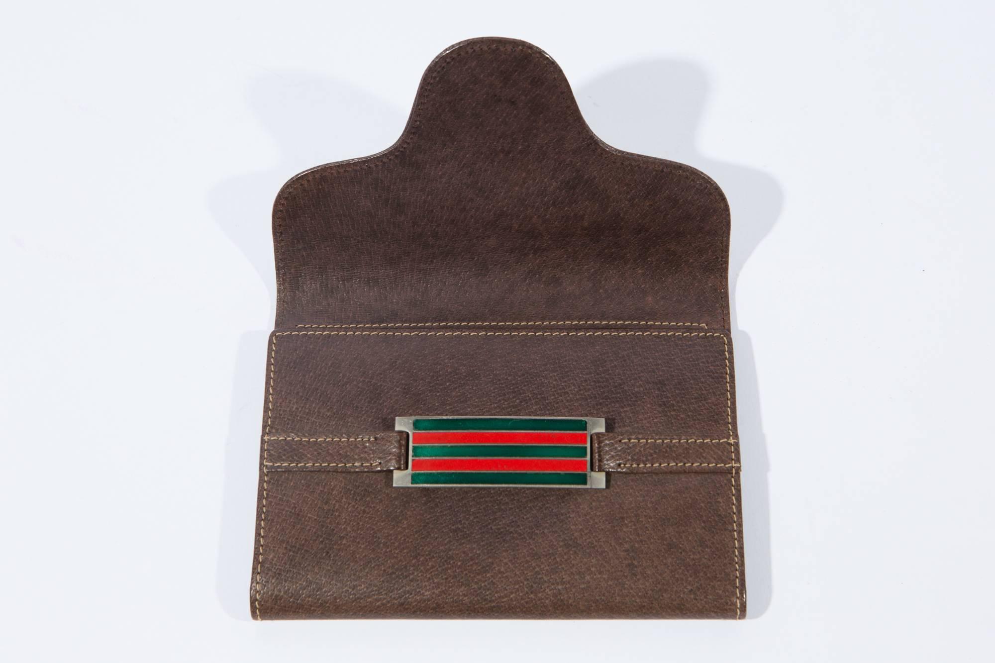 1970s Gucci  brown leather wallet featuring a front strap opening, inside  multiple interior compartments and an inside zipped pocket. Inside Gucci stamp. In excellent vintage condition. Made in Italy.
Closed 17cm x 12cm
Open 29cm x 17cm
