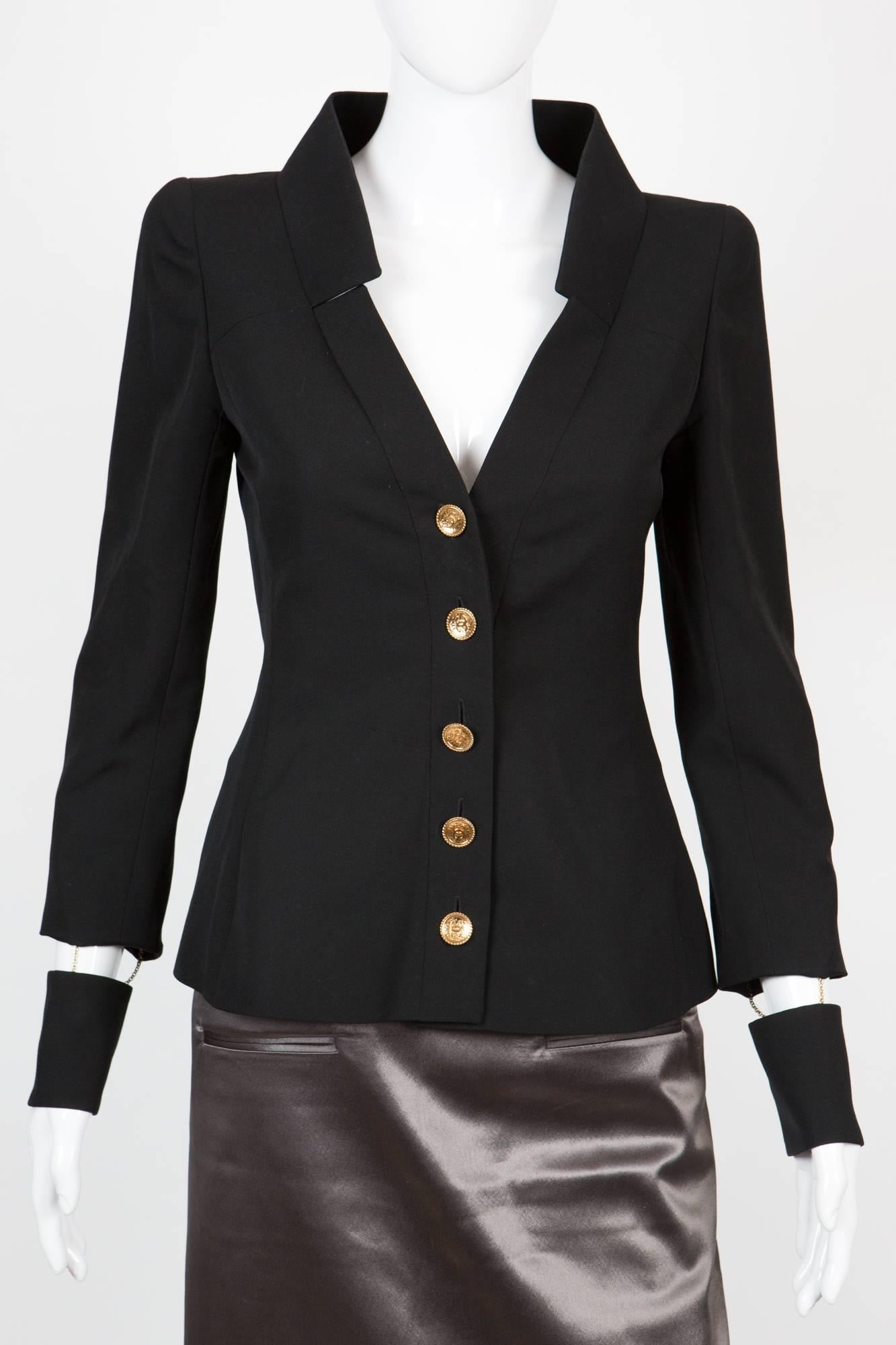 Stunning black Chanel wool jacket featuring a center front gold-tone logo buttons opening, a fancy cuff detail with logo buttons and gold tone chains to fix the cuff to the jacket, a silk logo lining, and a 24kt gilded gold hardware chain in the