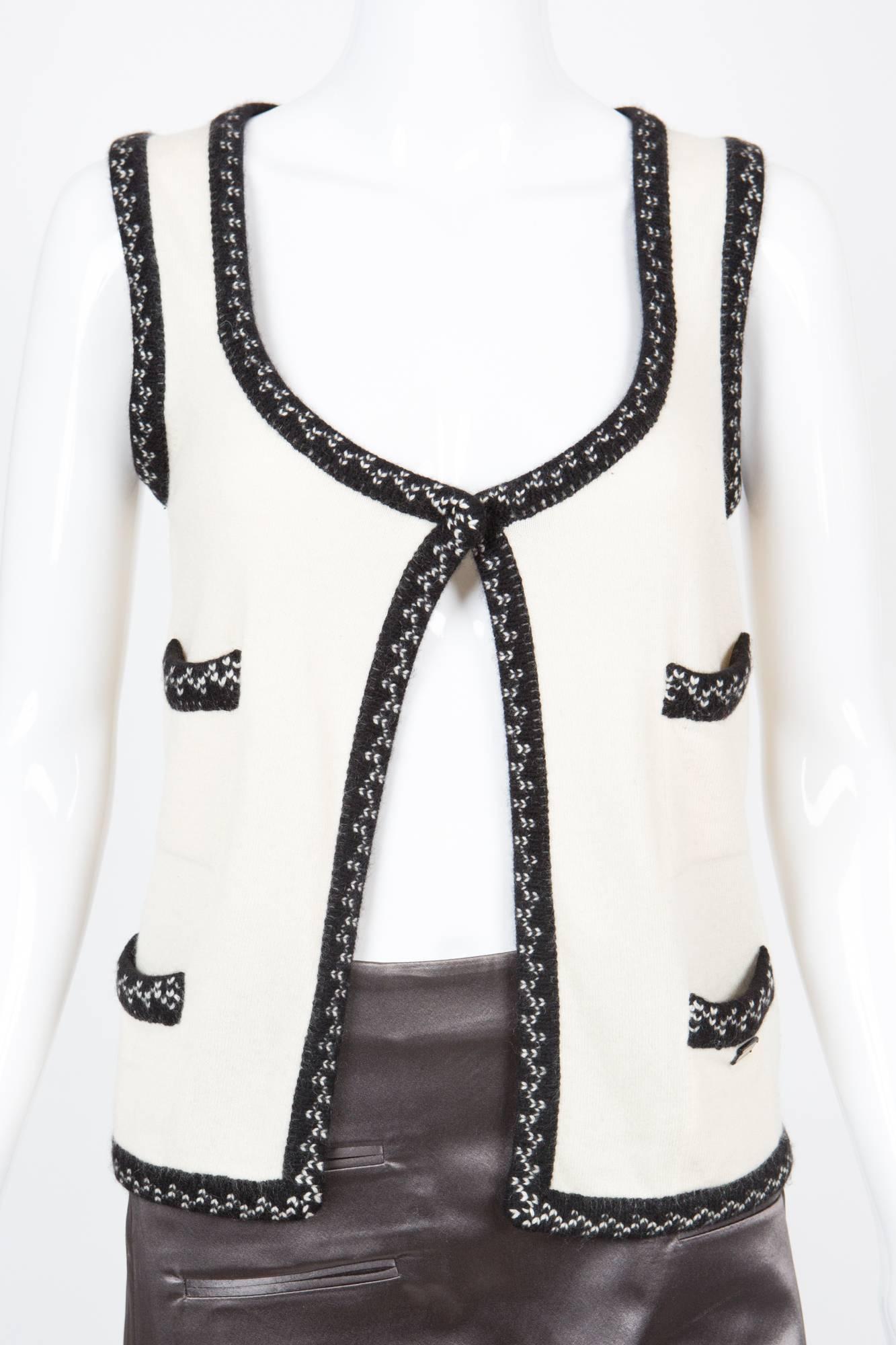 Gorgeous Chanel off-white 100% cashmere gilet  featuring a black cashmere jacquard finishing at neck front, bottom,  four  front patched pockets and a logo 
