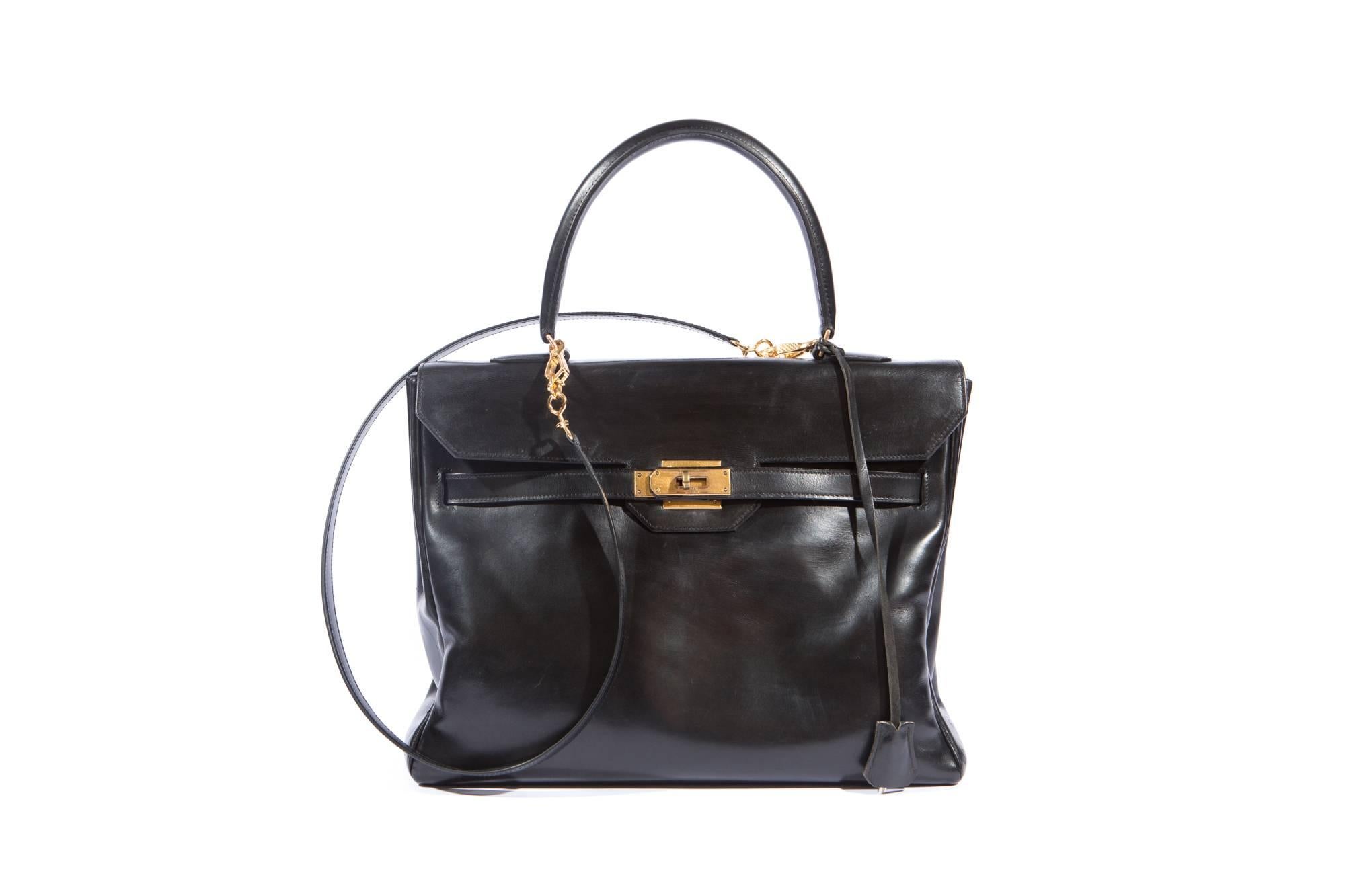 Fabulous Hermes Vintage black boxcalf Monaco bag in 32cm this classic bag features gold- plated hardware and comes with it's original clochette, key, a separated black box calf shoulder strap, (please note this black boxcalf shoulder strap has been
