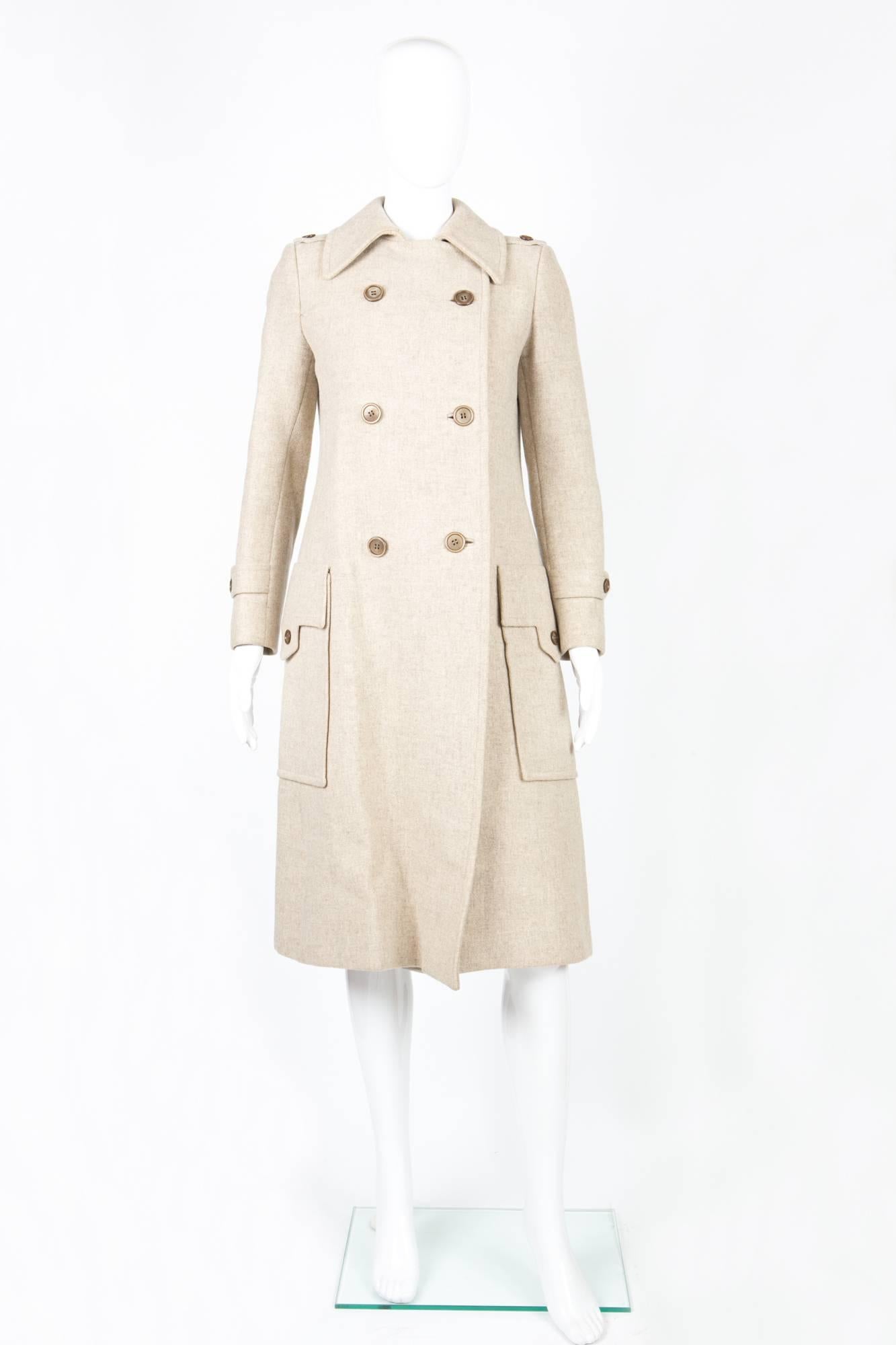 1960s Ted Lapidus ivory wool coat featuring a double breast opening, large patched pockets with side enter, shoulder straps, center back slit.
 In good vintage condition. Made in France.
Chest 36,2 in. ( 92 cm)
Waist 35,4 in. ( 90 cm)
Length