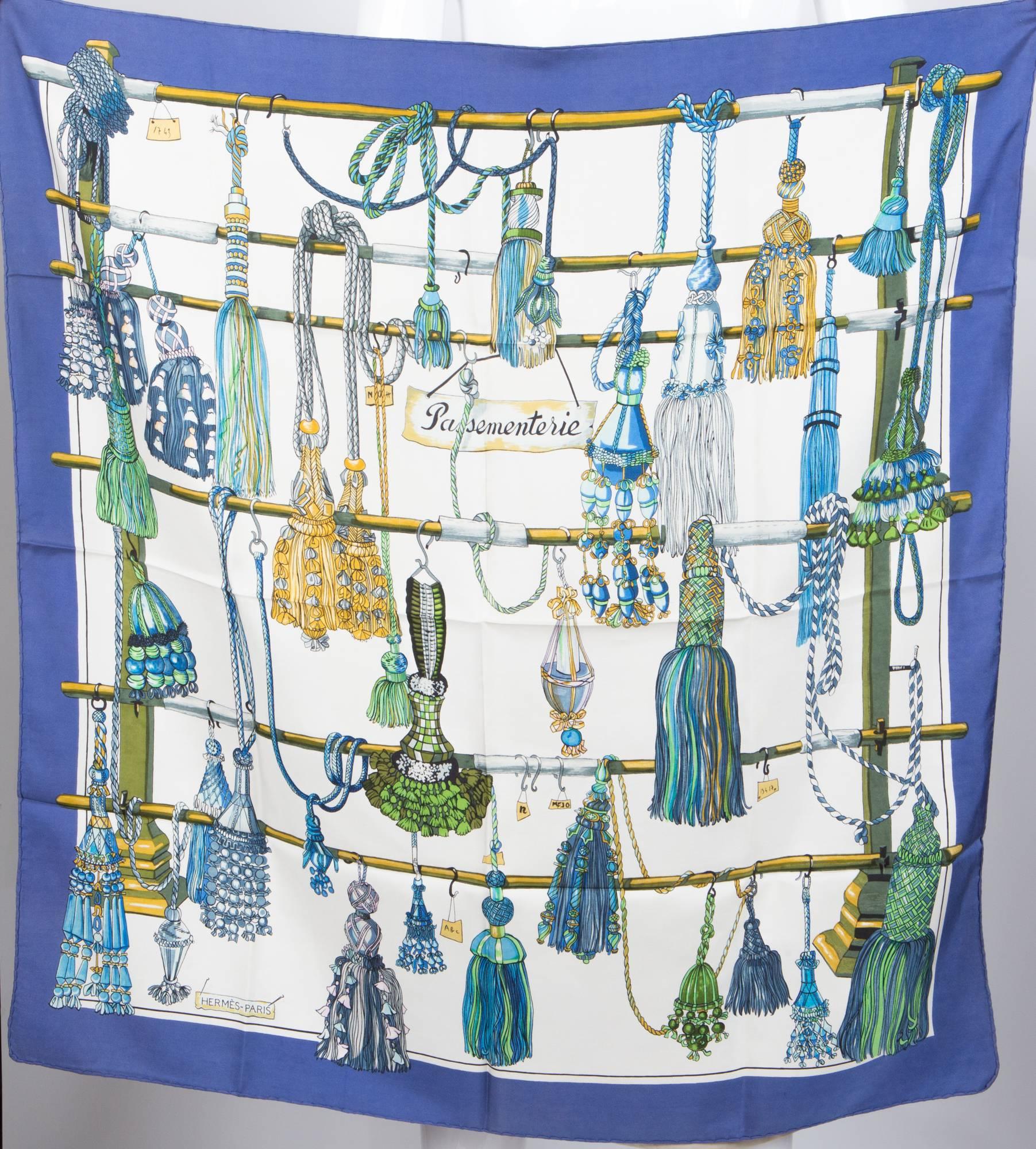 Rare blue gorgeous Passementerie Hermes Scarf featuring blue & amp, green tassels, hand rolled hem.Passementerie was designed by Francoise Heron and first issued in 1960, At the beginning of the 1960s, Robert Dumas, then president of Hermès, was