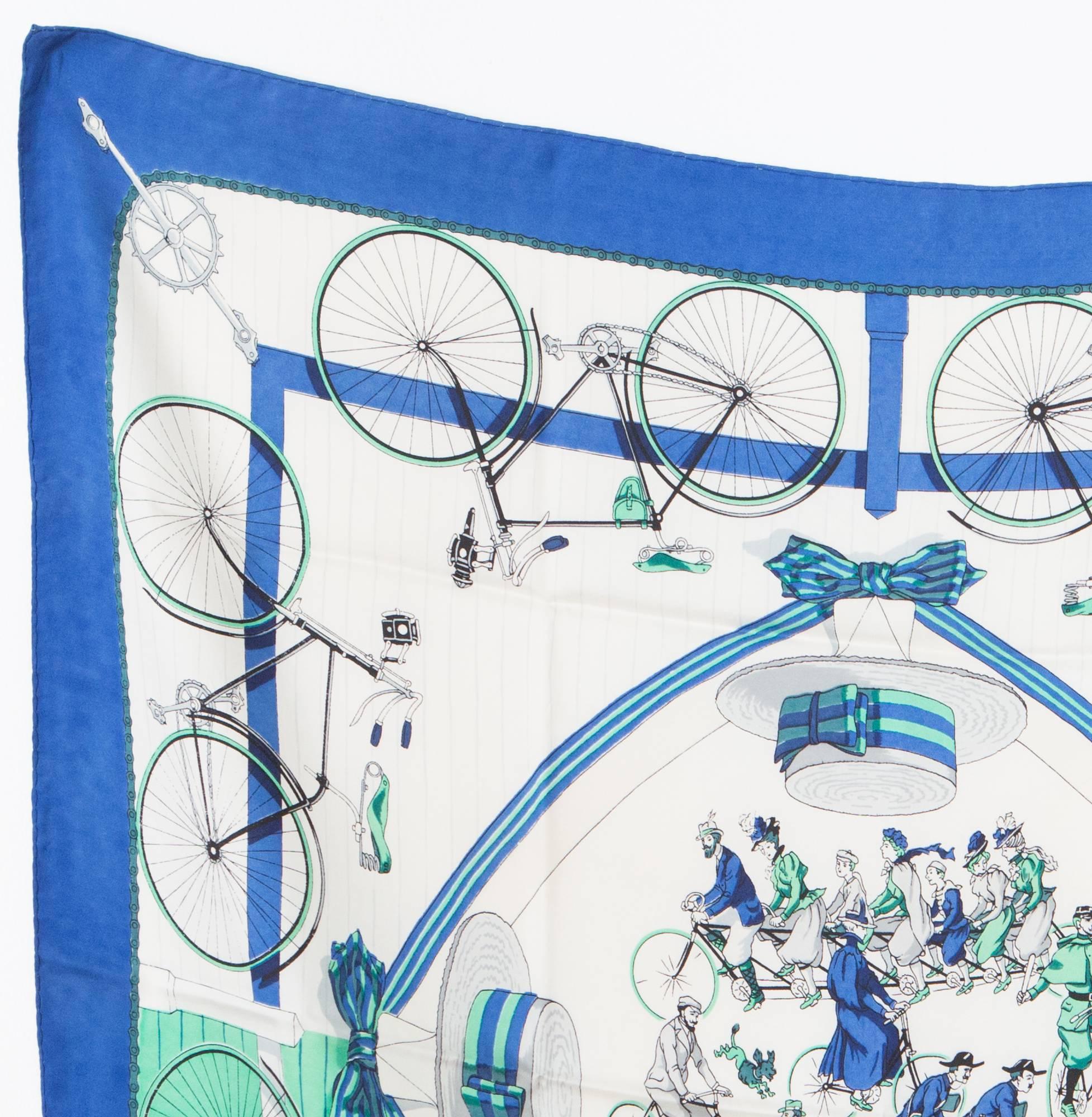 Blue & green Hermès  Les Becanes by Hugo Grygkar silk scarf featuring a Victorian bicycle print. This scarf was designed by Hugo Grygkar and first issued in 1954 with reissues in 1973, 1990 and 2003. 
35,4in. (90cm) X 35,4in. (90cm)  In