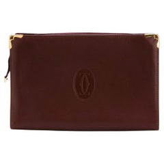 Bolso de mano unisex de piel color burdeos de Cartier