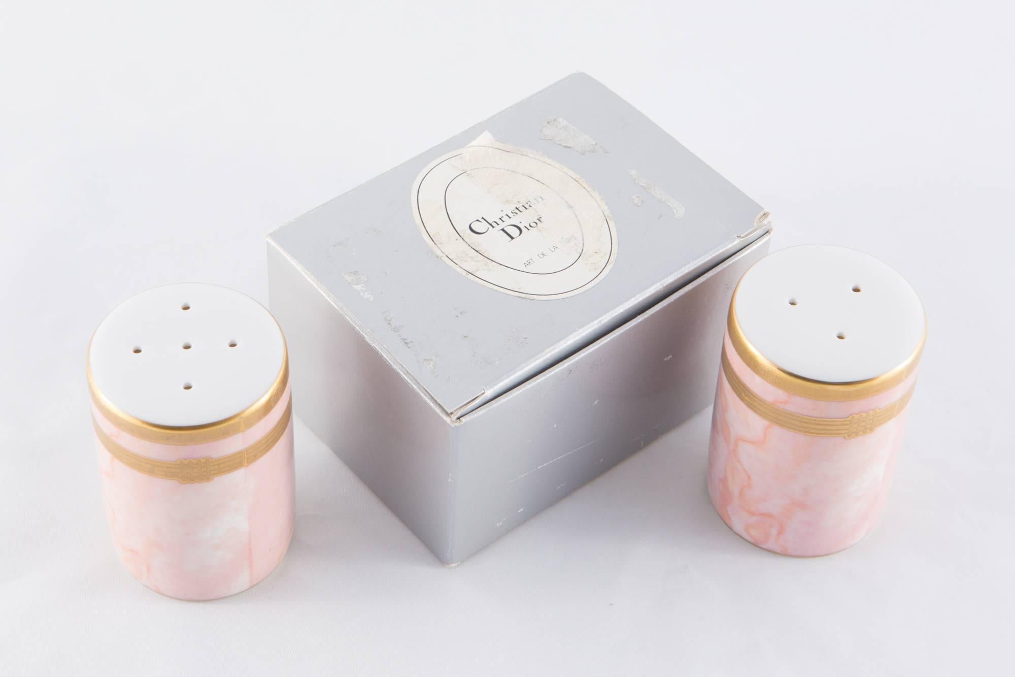 Christian Dior french marble pink and gold paint salt and pepper porcelain shakers featuring a bottom plastic opening, logo Christian Dior on th top first gold bans ( see photo), delivered in their original box "Christian Dior" with