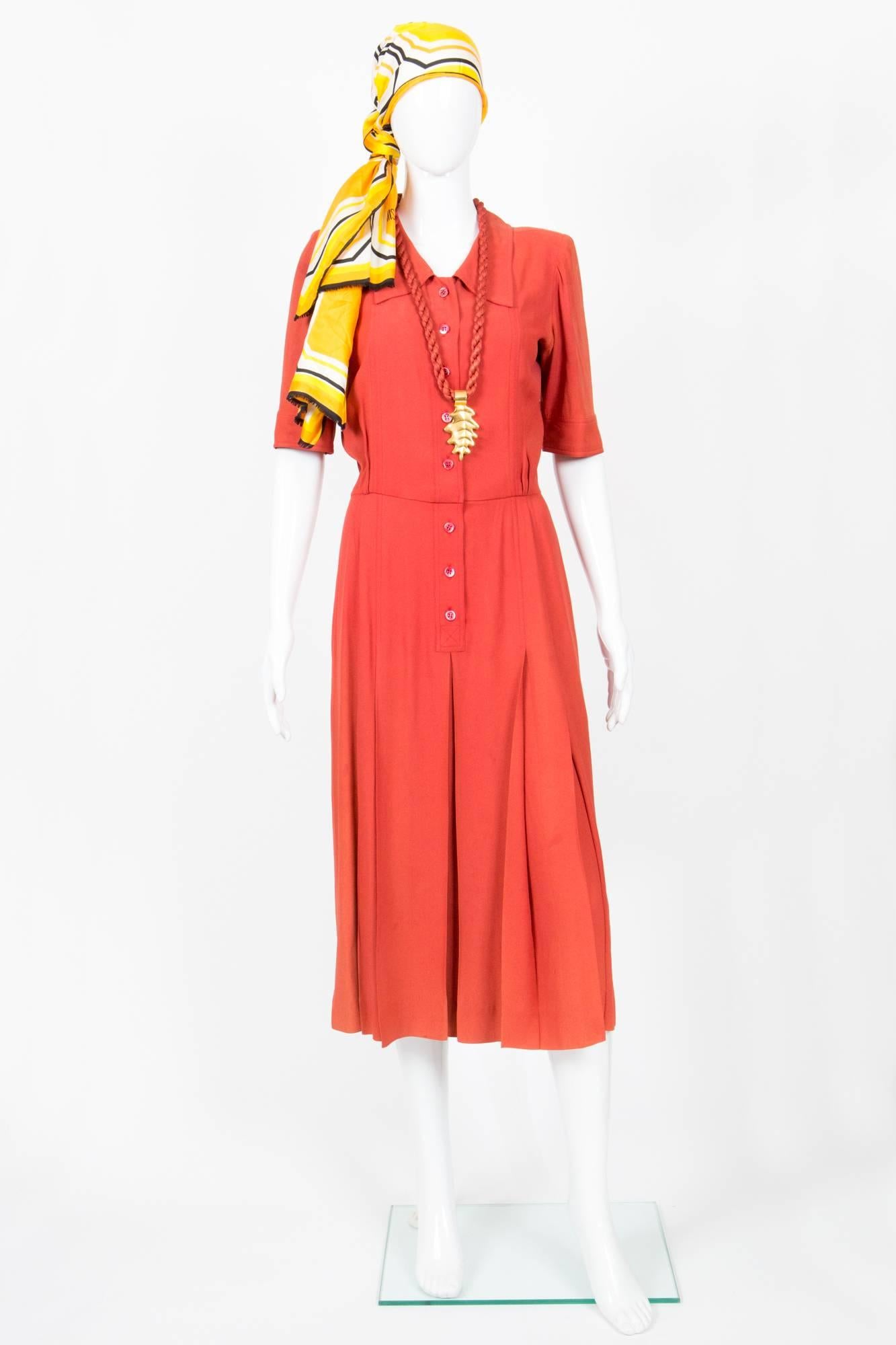 1960s rare collector orange crepe Yves Saint Laurent dress featuring a classic collar, short sleeves, a front button opening, a pleated skirt part. Rare for collection.
In fair condition. Made in France. (small spots on, shades at under arms)
