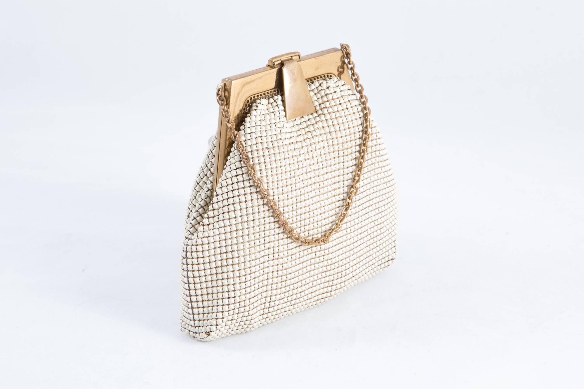 1920s Whiting & Davis ivory mini-evening small beaded bag featuring gold tone top closure, small chain handle inside silk lining. 
In good vintage condition. Made in USA.
Measurements:4,7in (12cm) X Bottom Width 5.5in. (14cm)  
Total Handle:17.8in.