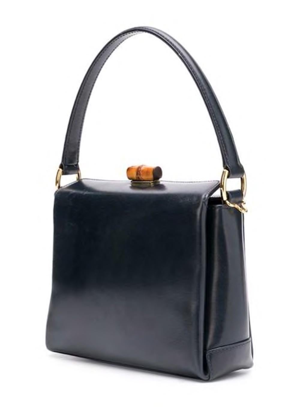 Gucci navy blue leather mini square tote bag featuring a round top handle, a Bamboo foldover top with twist-lock closure, a main internal compartment, an internal zipped pocket, an internal logo patch, gold-tone hardware and a structured design.