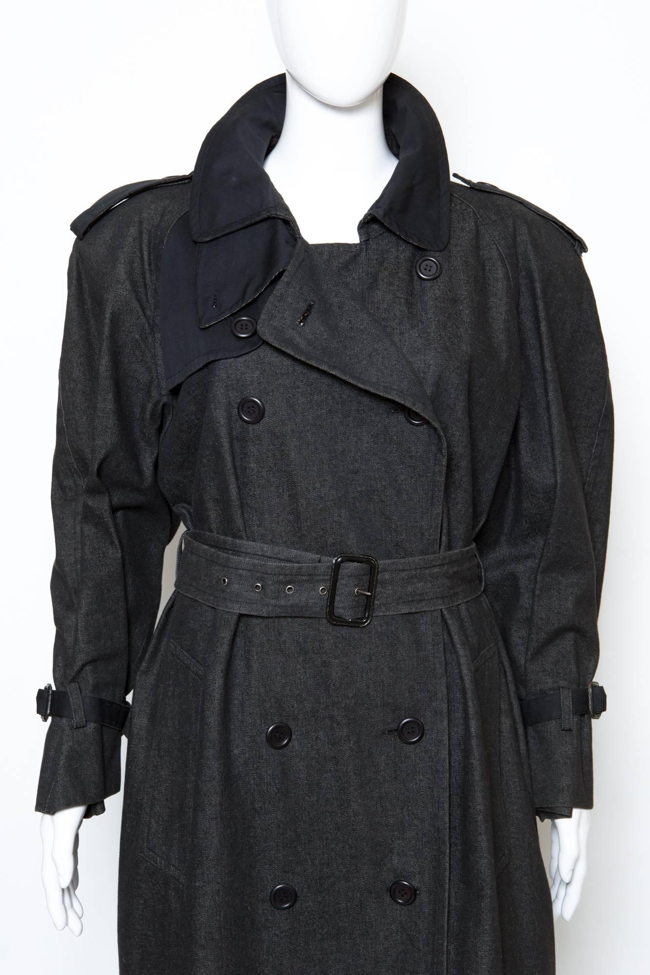 Yves Saint Laurent  black denim long trench-coat with plain black cotton details, featuring all trench details at shoulder, back and cuffs. 
This trench is bi-fabric with black cotton and gets a double breast front opening, and a seperated belt