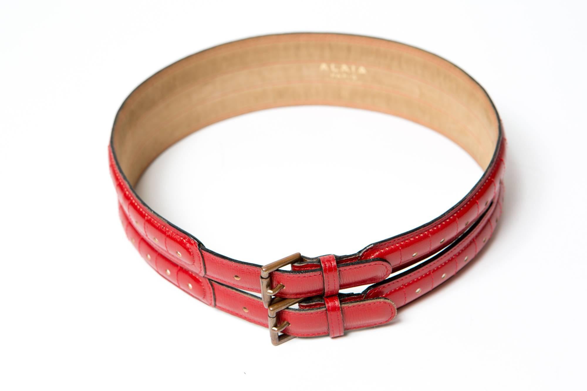 1990s ALAIA  large red leather corset  belt featuring a hole detail, two buckles. 
Size label: 70
Maxi lenght: 6cm X 77cm