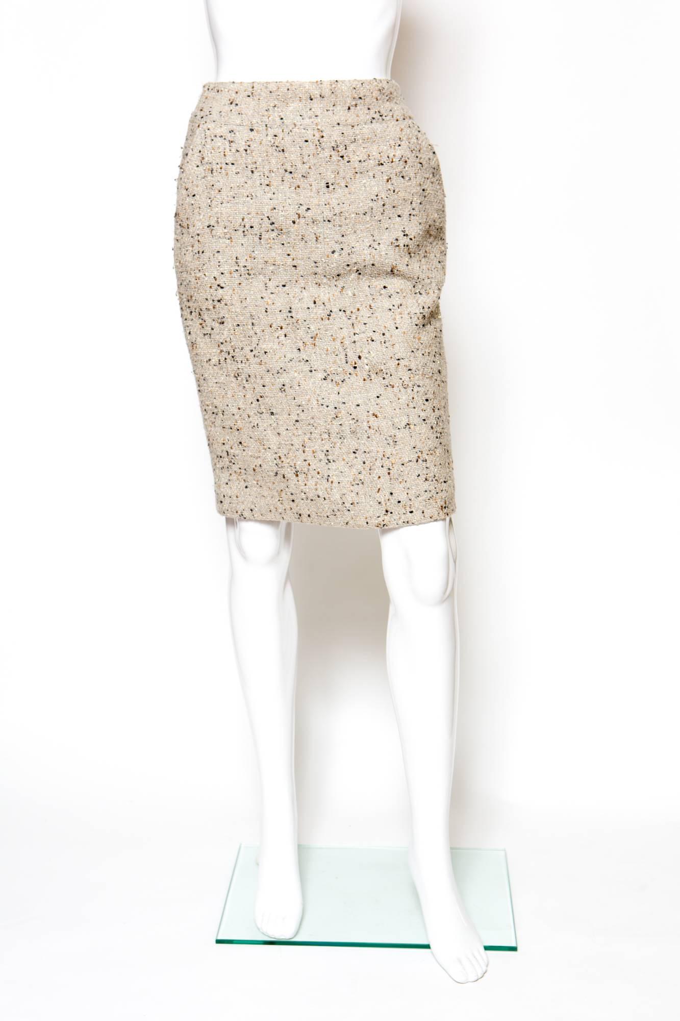  Chanel camel tweed and lurex short pencil skirt( 87 %wool, 13% polyamide) featuring a bottom center back slit logo zip: 17cm,2 logo buttons at center back waistband, 2 front pockets, and a fully silk lining.  
Chanel label size 34fr

